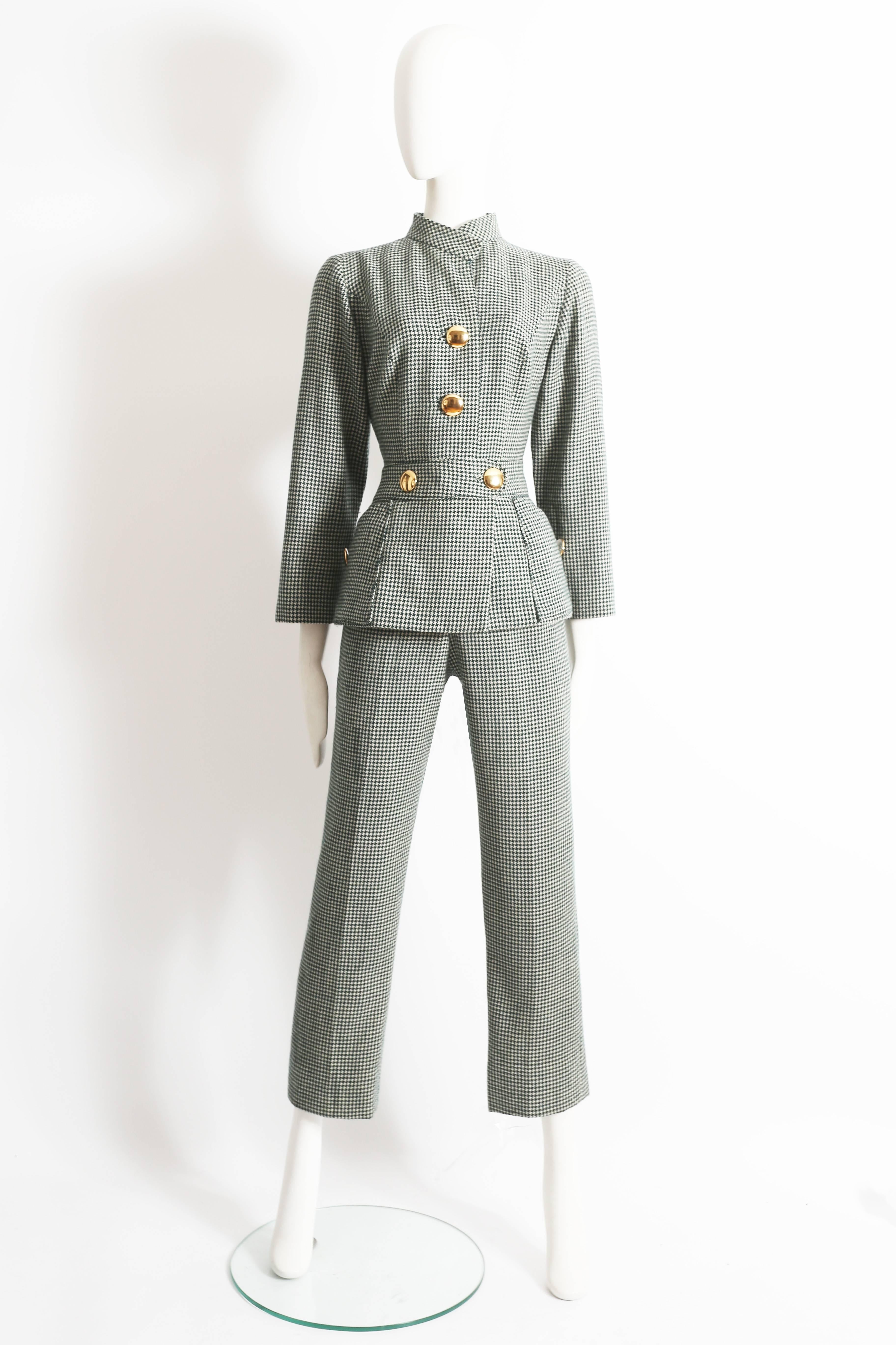 Presenting a stylish green and white houndstooth wool jumpsuit, a timeless treasure dating back to the chic 1960s era. This jumpsuit exudes elegance and sophistication, showcasing the classic houndstooth pattern in a modern and contemporary