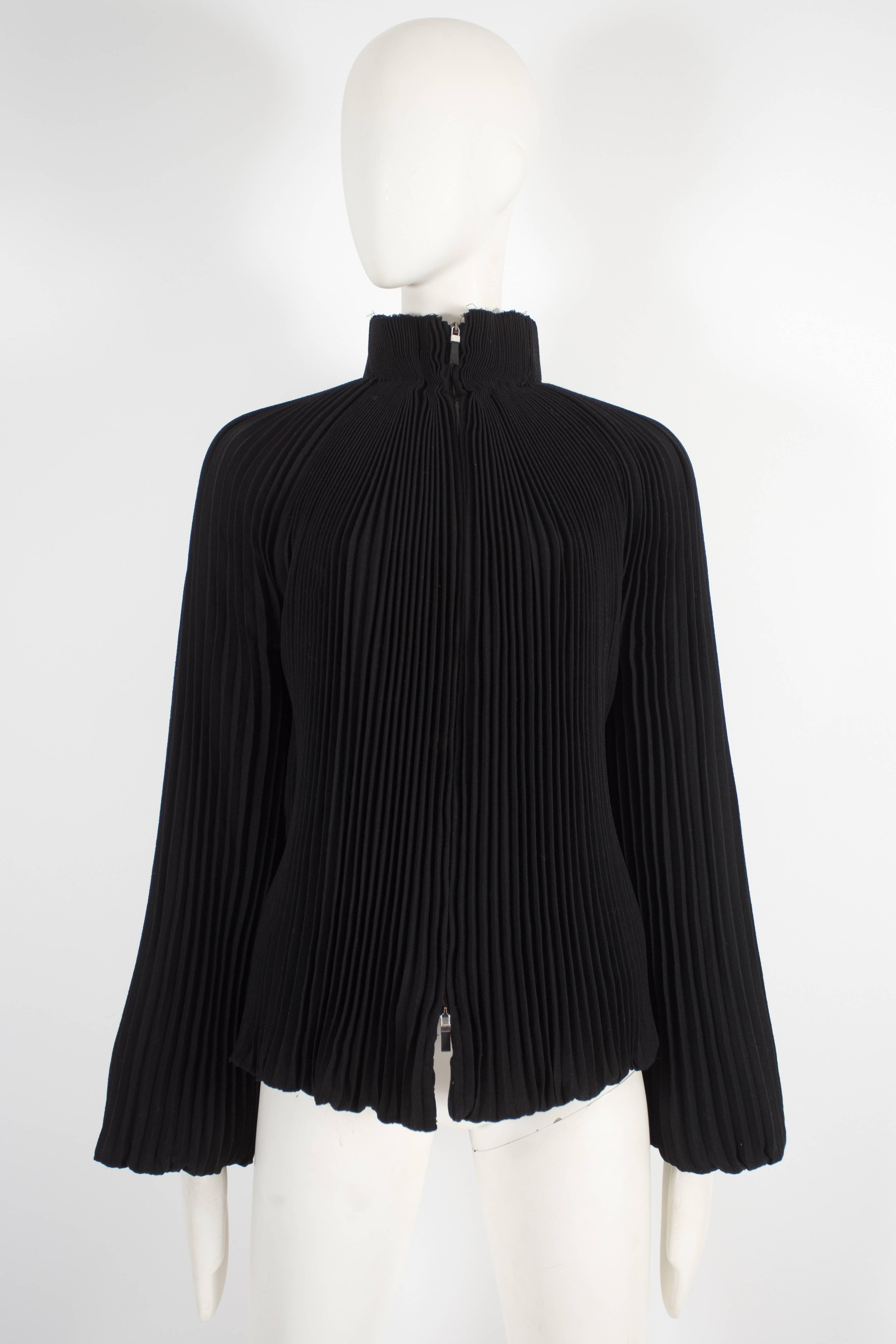 Introducing an exquisite Alexander McQueen evening jacket from the pre-fall 2004 collection. This jacket is a true masterpiece, showcasing the brand's signature craftsmanship and design.

Constructed in accordion pleated black wool crepe throughout,