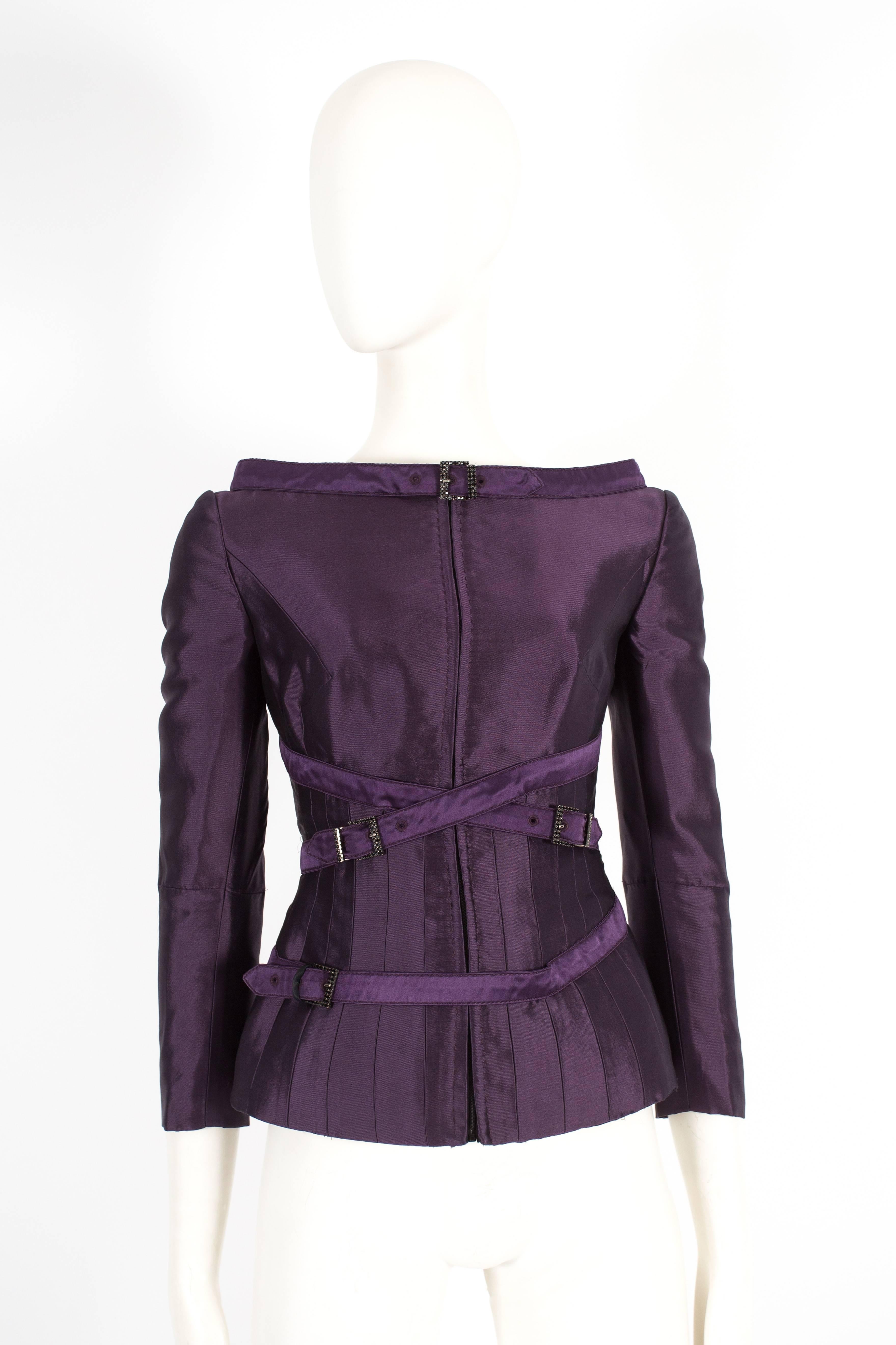 Introducing a captivating Alexander McQueen evening jacket from the autumn-winter 2007 collection. This jacket is a true representation of the brand's innovative design and luxurious craftsmanship.

Constructed in a rich plum silk taffeta, the