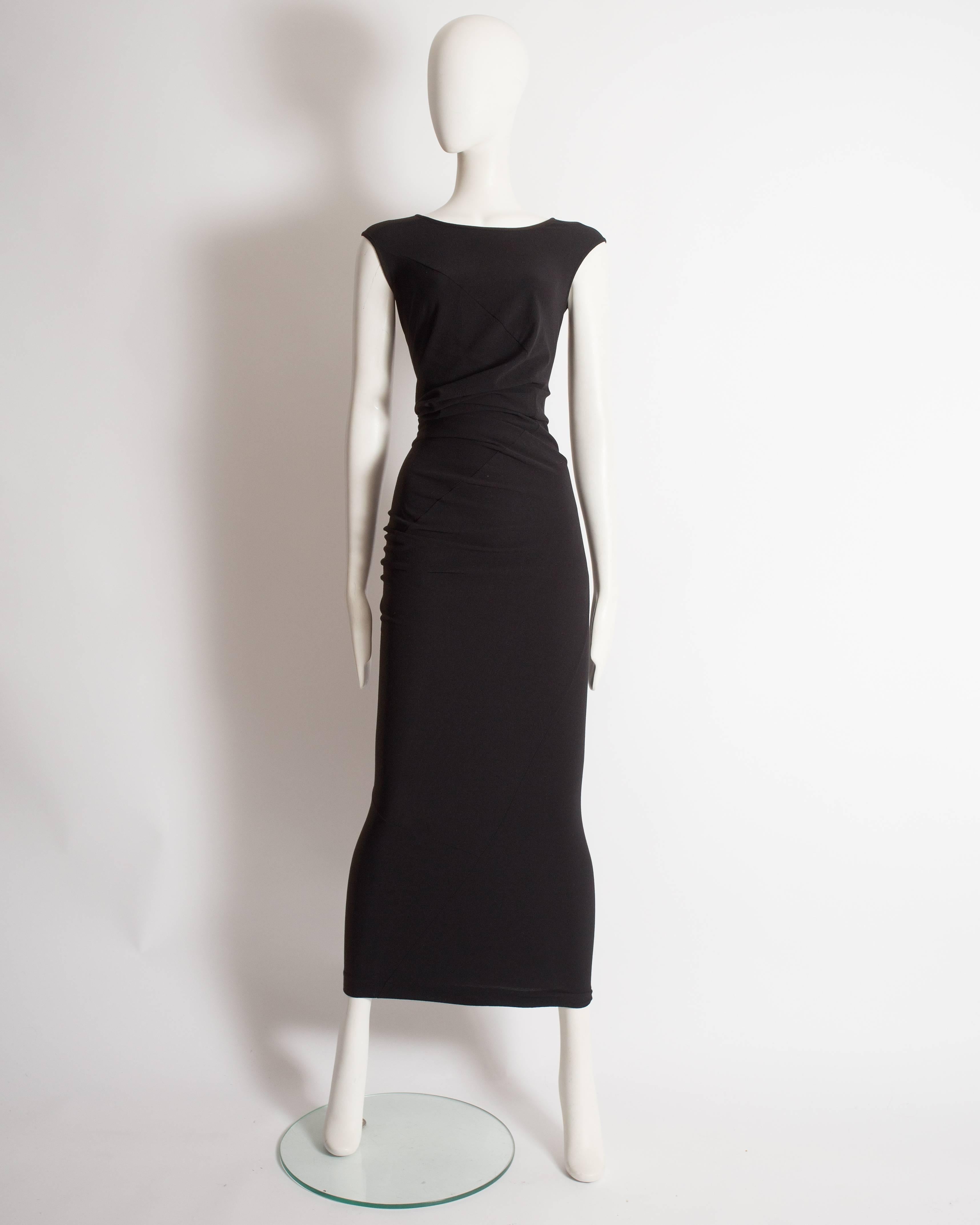 Fine and rare Comme des Garcons black stretch evening dress from the 'Body Meets Dress, Dress Meets Body' spring-summer 1997 collection. Constructed in black stretch fabric with irregular deconstructed seams throughout. Originally worn on the runway