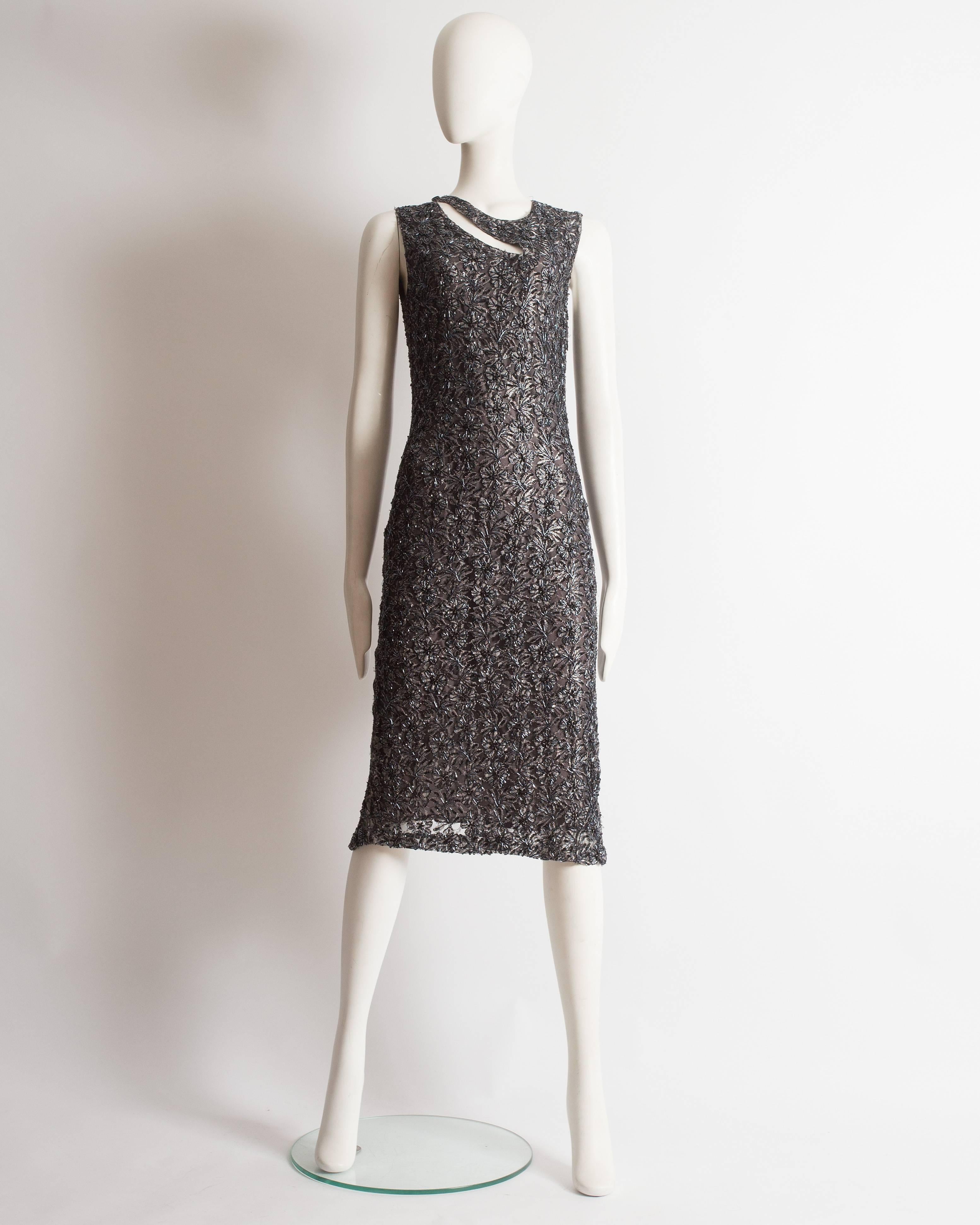 Presenting an enchanting Alexander McQueen sleeveless evening dress, a true masterpiece of elegance and artistry. This dress is constructed from steel grey lace, beautifully adorned with bugle beads and sequins, adding a touch of opulence and
