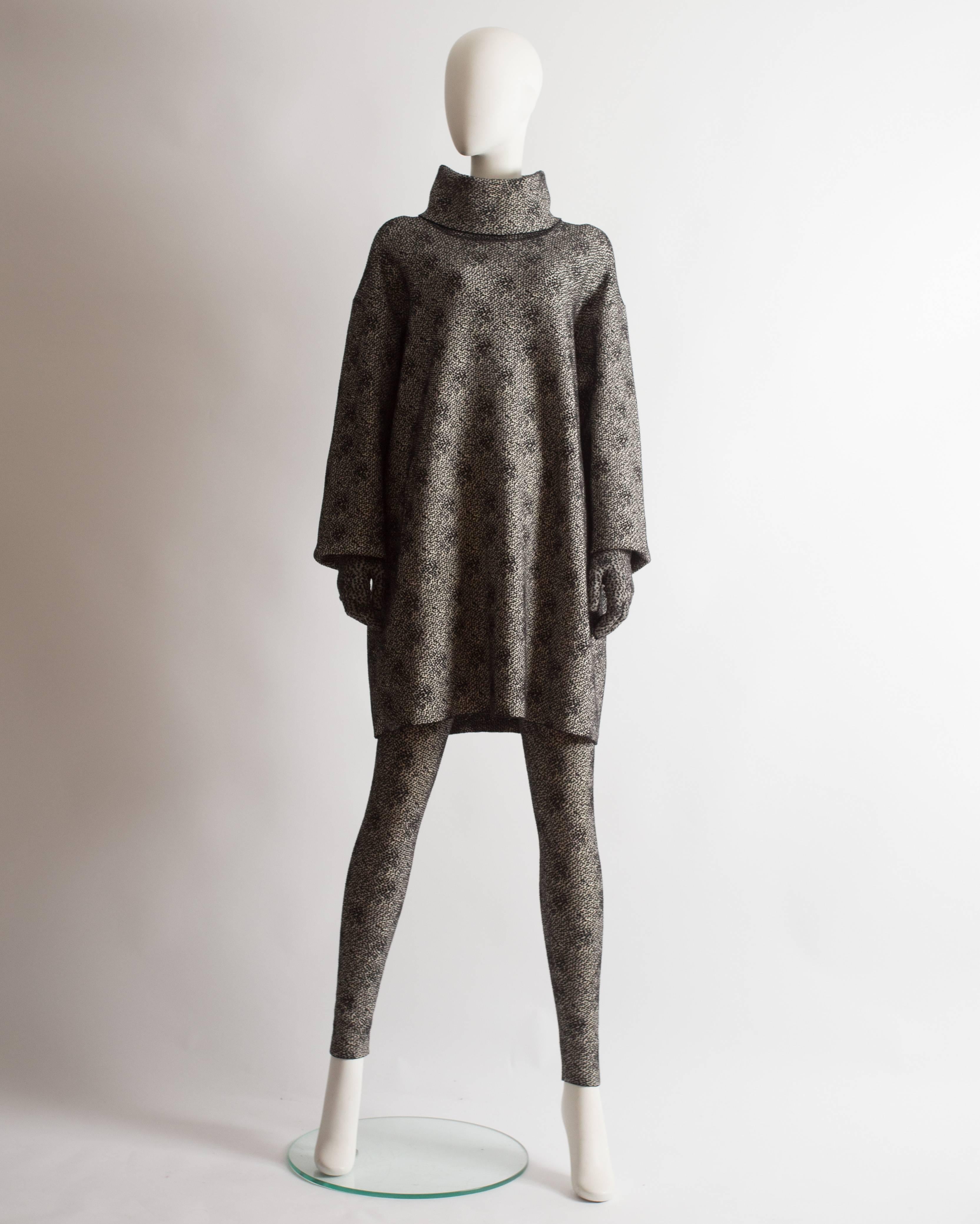 Alaia three piece ensemble. Oversized sweater dress with high turtle neck and two zip fastenings, high waist fitted leggings and matching gloves. 