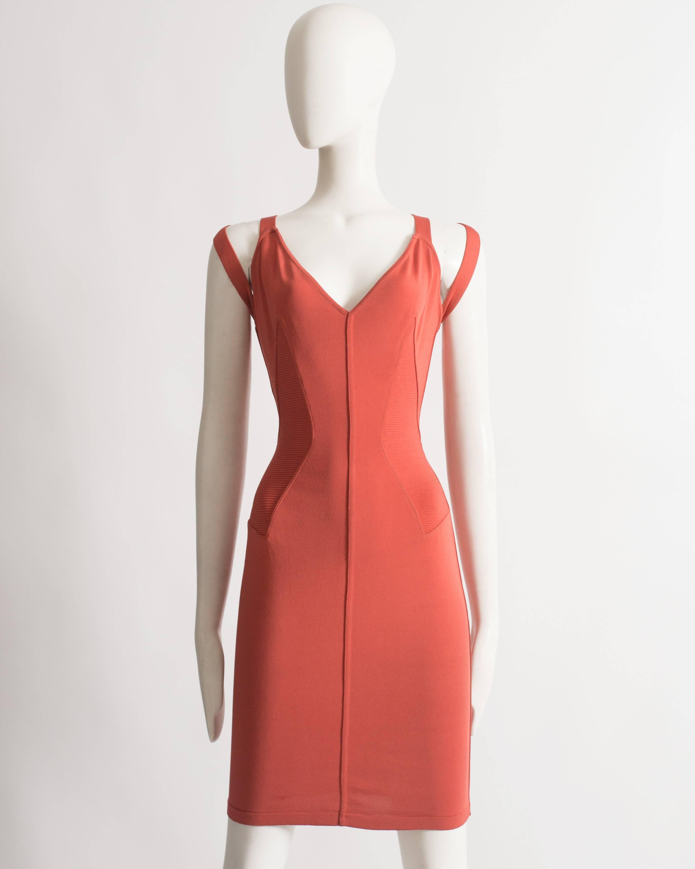 Alaia coral spandex evening dress with bondage straps and ribbed panels.

Spring-Summer 1990