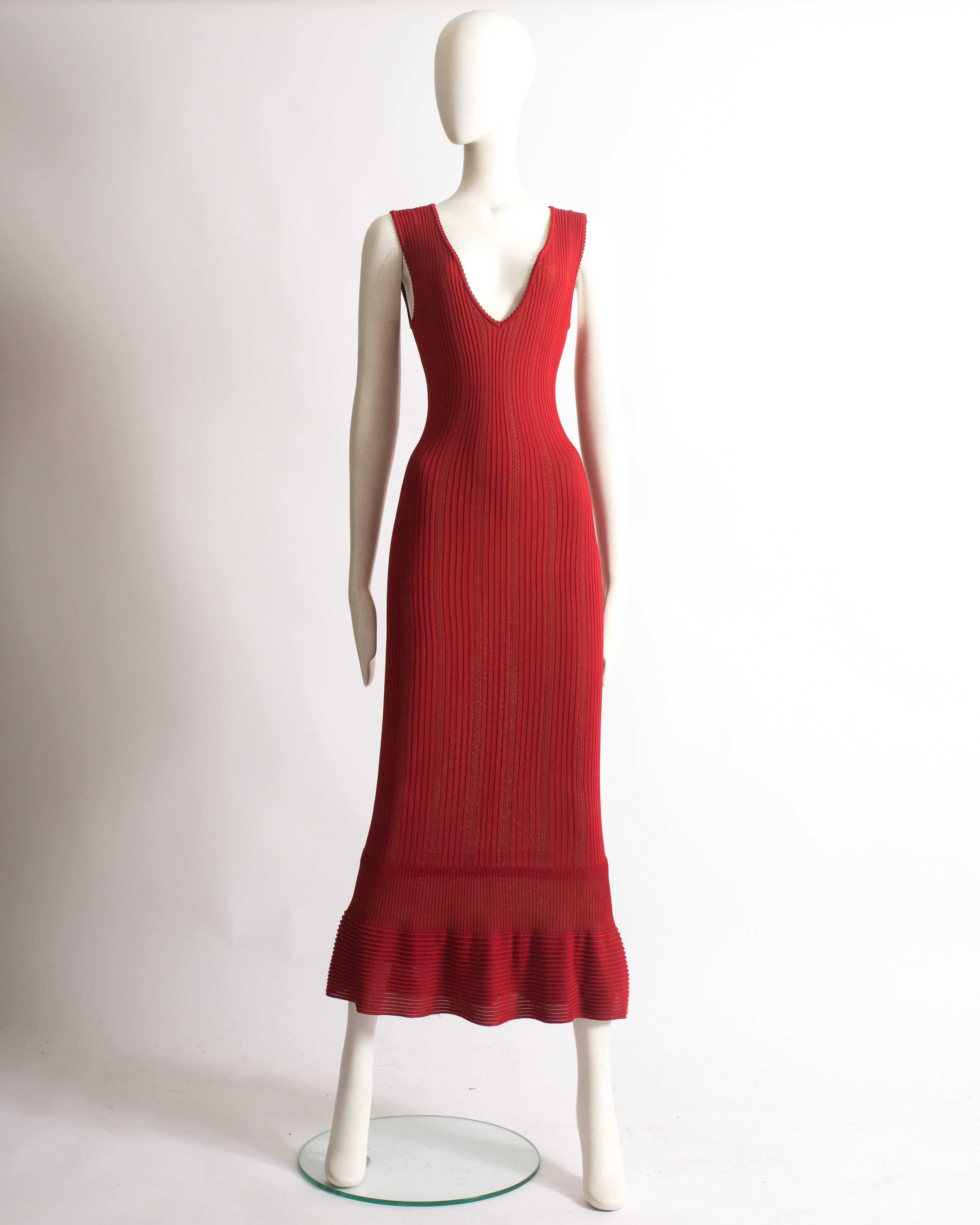 Presenting an alluring Azzedine Alaia red ribbed knit evening dress, a true masterpiece from the spring-summer 1996 collection. This dress showcases the designer's unparalleled craftsmanship and exquisite design.

The ribbed knit fabric creates a