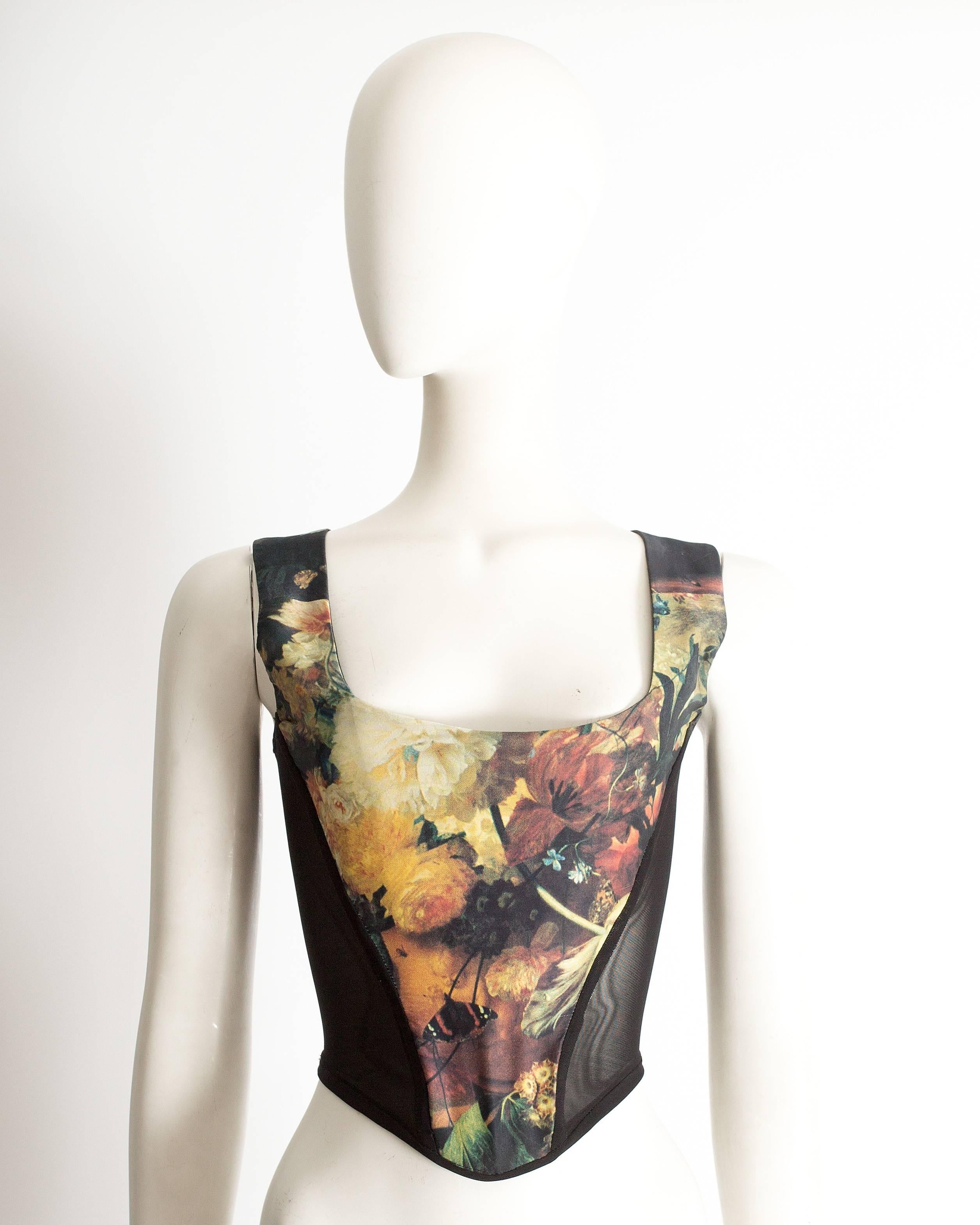 Vivienne Westwood floral print corset with black mesh side panels, internal boning and zip fastening at the back. 

''Vive la Cocotte' Autumn-Winter 1995