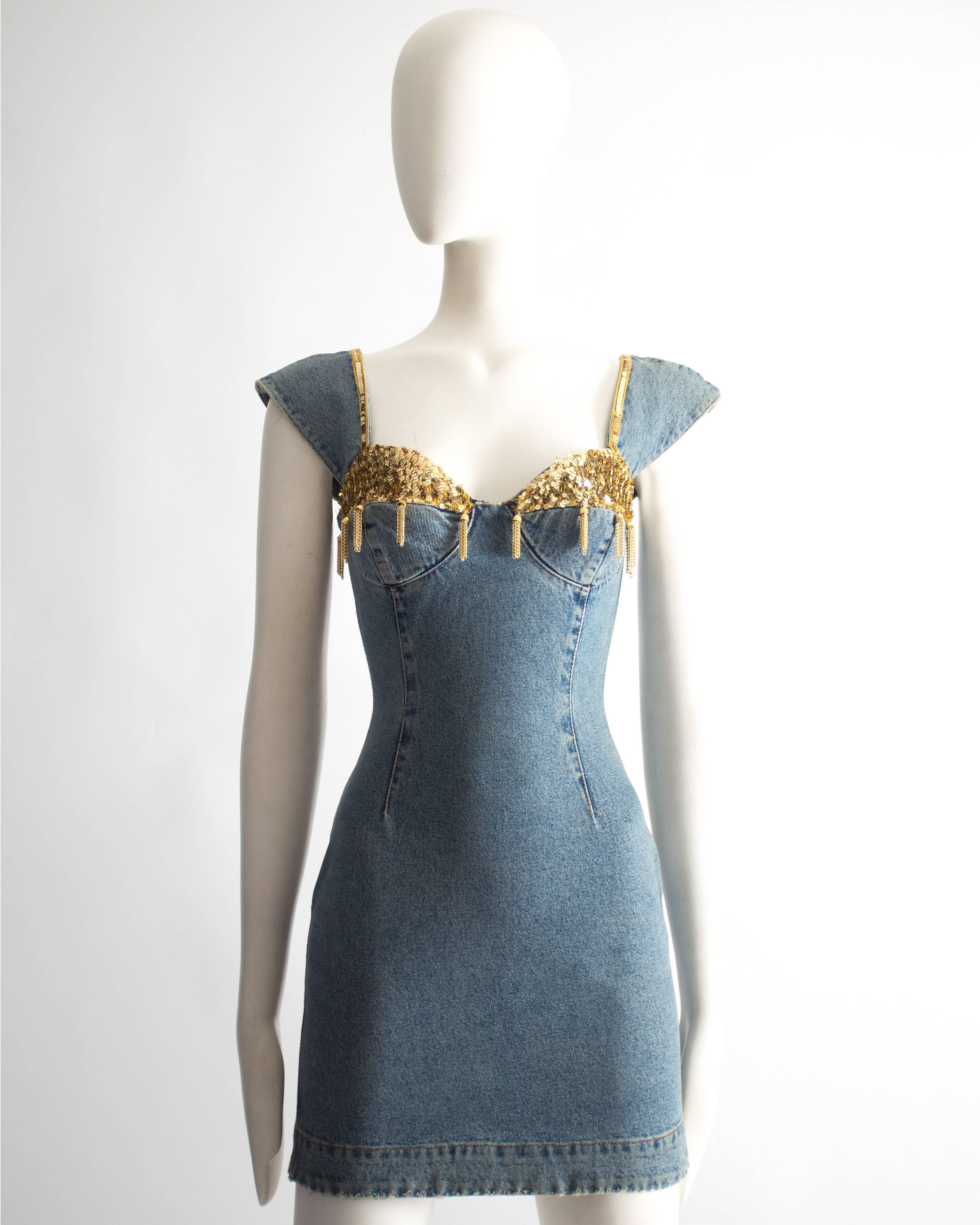 Katharine Hamnett denim mini dress. Sequin bust with chain tassels, capped sleeves, zip fastening at the back and two zip pockets.