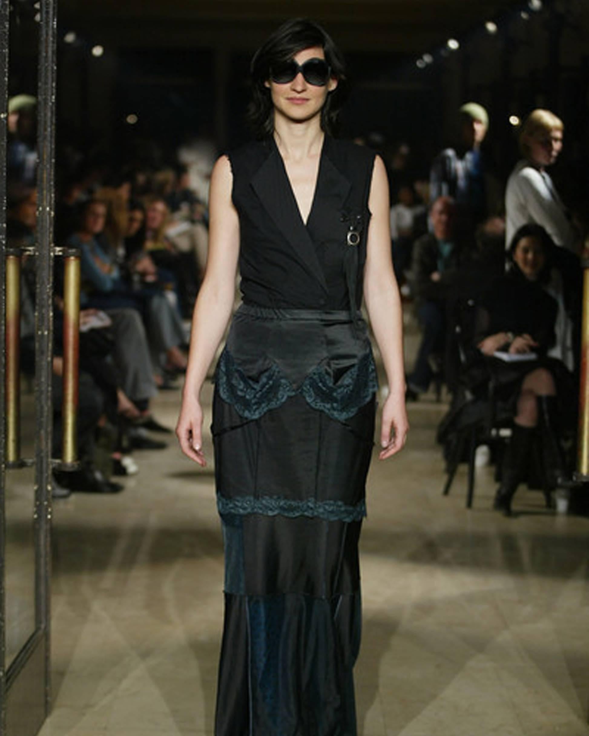 Introducing a unique Maison Martin Margiela Spring-Summer 2003 black polyester artisanal lingerie dress, thoughtfully reconstructed into a versatile skirt. This reconstructed piece captures the brand's artistic approach to fashion and reimagining