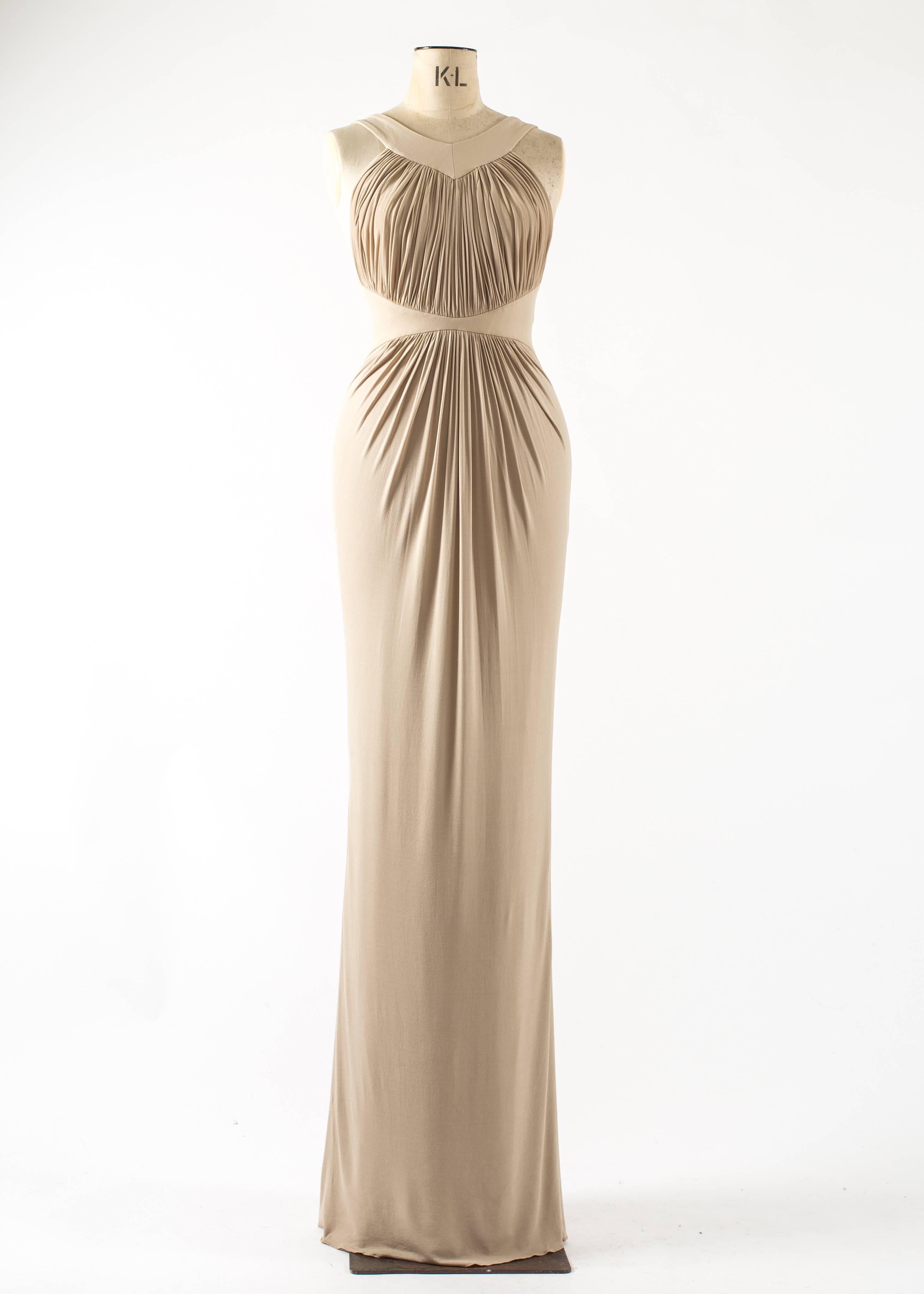 Presenting the exquisite Guy Laroche by Hervé Leroux (Hervé Léger) from the Spring-Summer 2006 collection. This stunning dress showcases the designer's mastery in creating elegant and figure-enhancing silhouettes.

Crafted from a luxurious beige