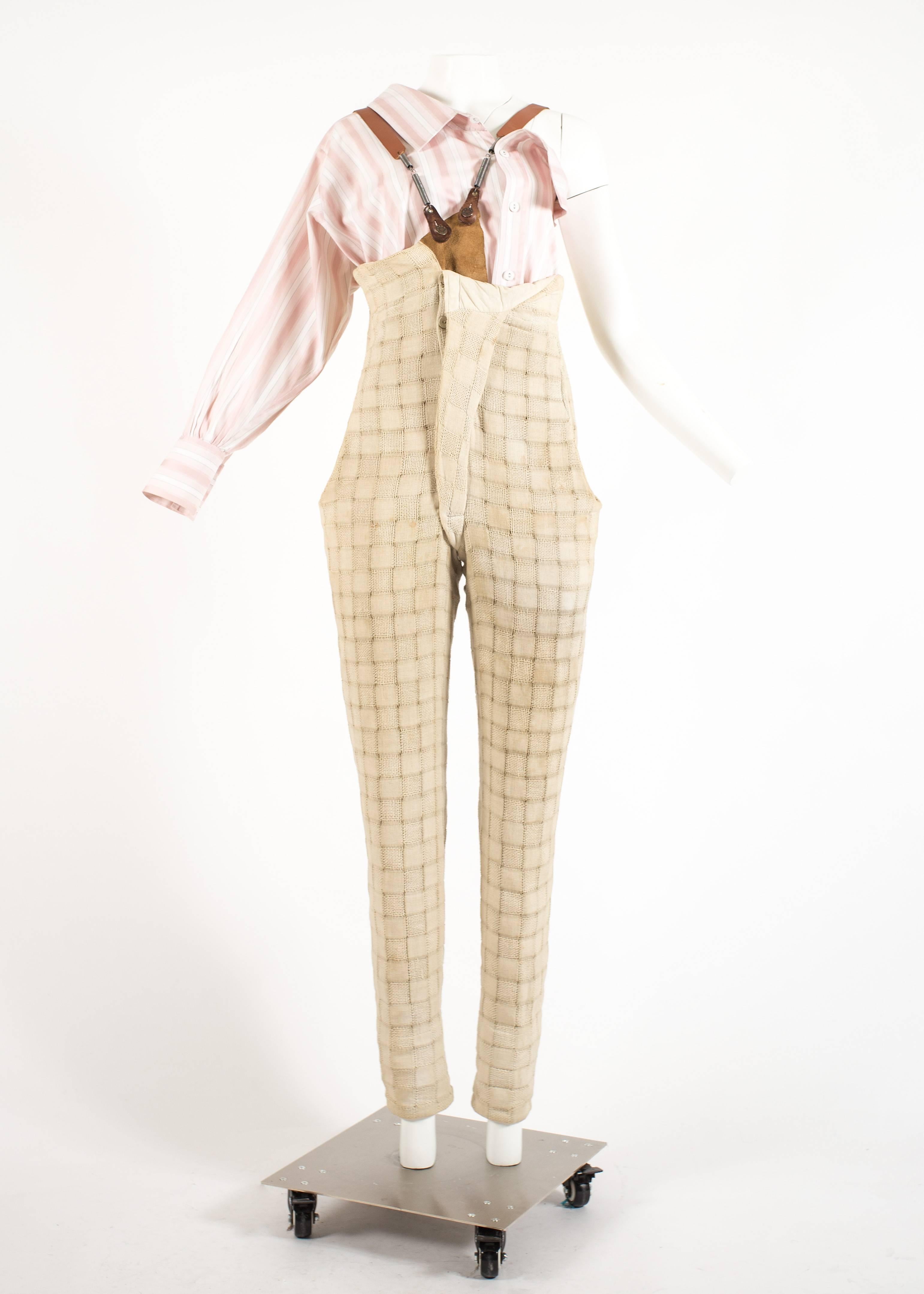 Introducing the revolutionary Worlds End by Vivienne Westwood and Malcolm McLaren 'Punkature' ensemble from the Spring-Summer 1983 collection, a symbol of rebellion and innovation.

The ensemble features a one-sleeved pink and white striped cotton