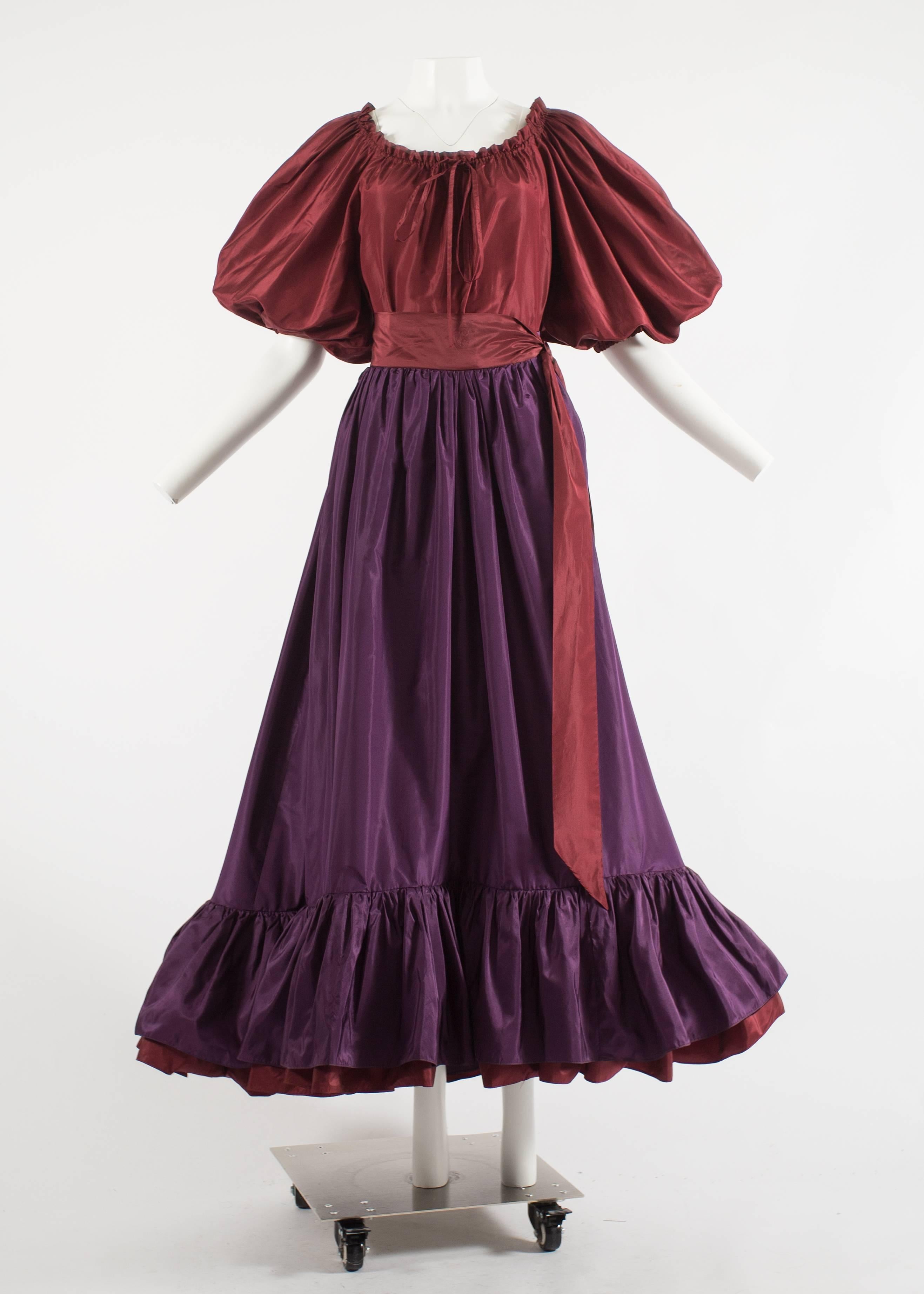 Yves Saint Laurent 1978 silk taffeta blouse and skirt ensemble 

- Burgundy blouse with drawstring collar, bow fastening, and balloon sleeves with elasticated cuff. 

- High waisted tiered plum skirt with a burgundy sash, fastening with a long