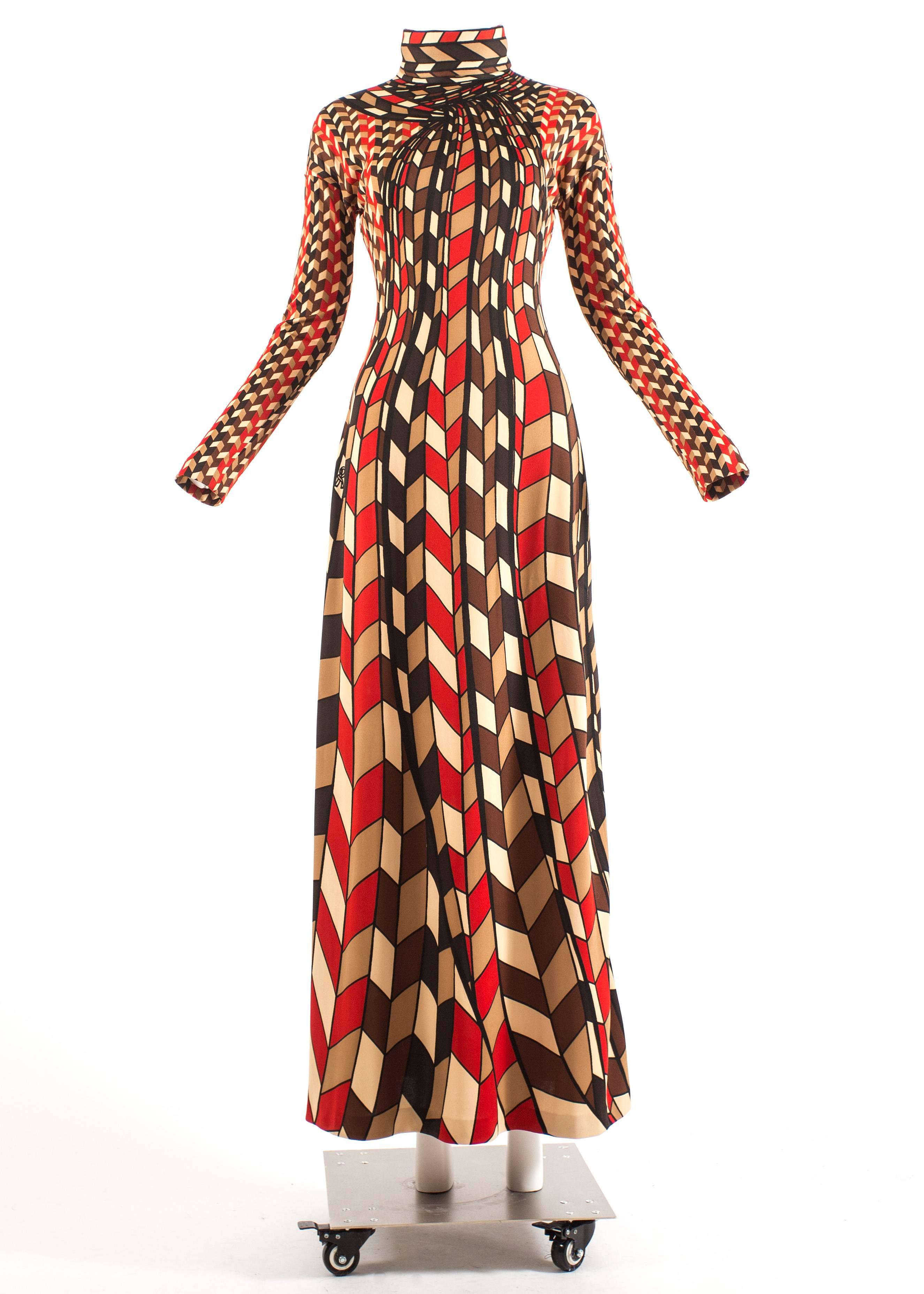 Roberta di Camerino 1976 jersey geometric scarf print maxi dress

- dressed in a panel-printed polyester jersey in a bared wire scarf print, which reproduces a large scarf rolled around the neck in red, brown, cream and navy blue.

- zip fastening