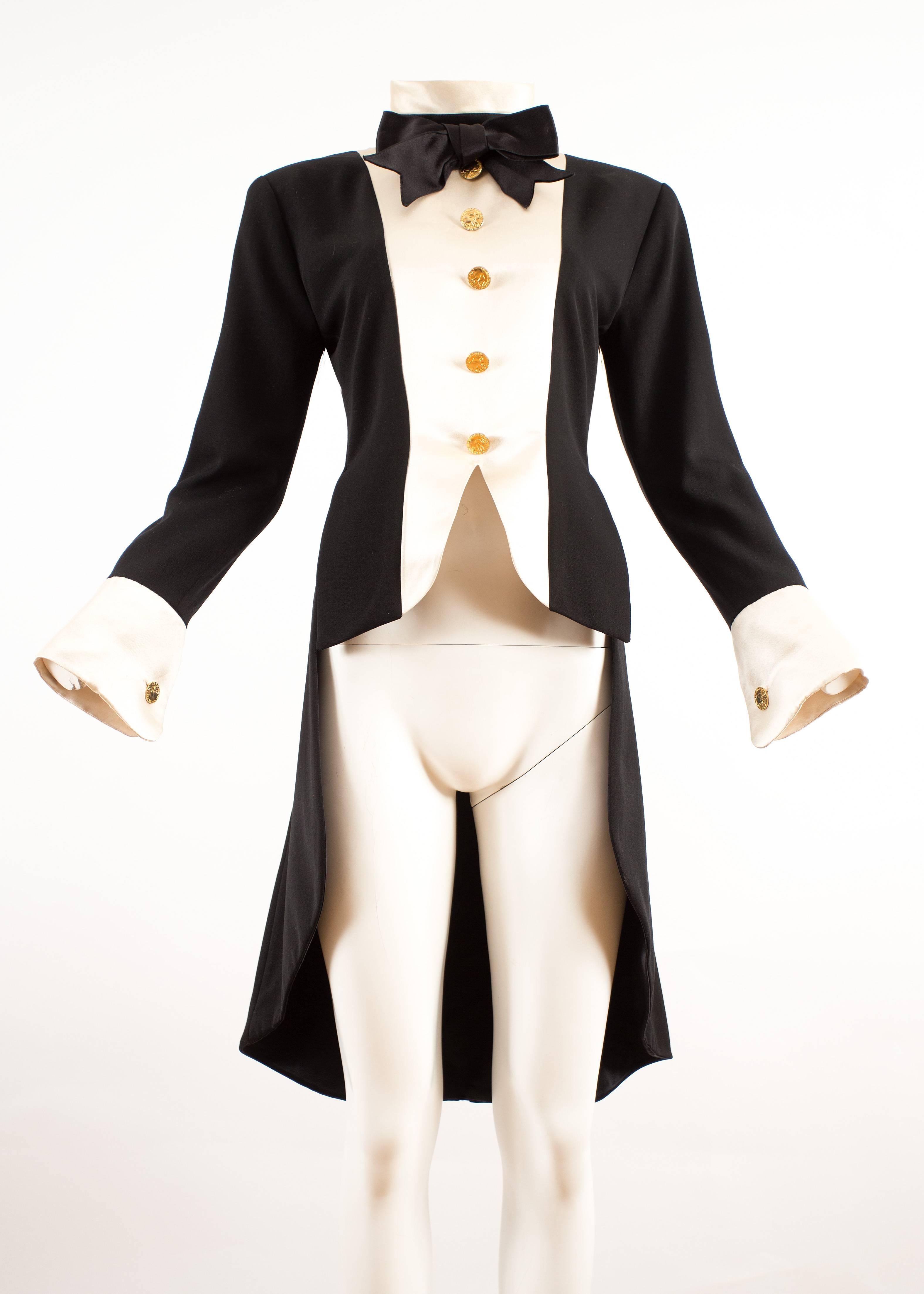 Chanel 1980s black silk evening tailcoat 

- gold-tone buttons
- ivory coloured silk 
- black silk bow tie 
- zip fastening 
