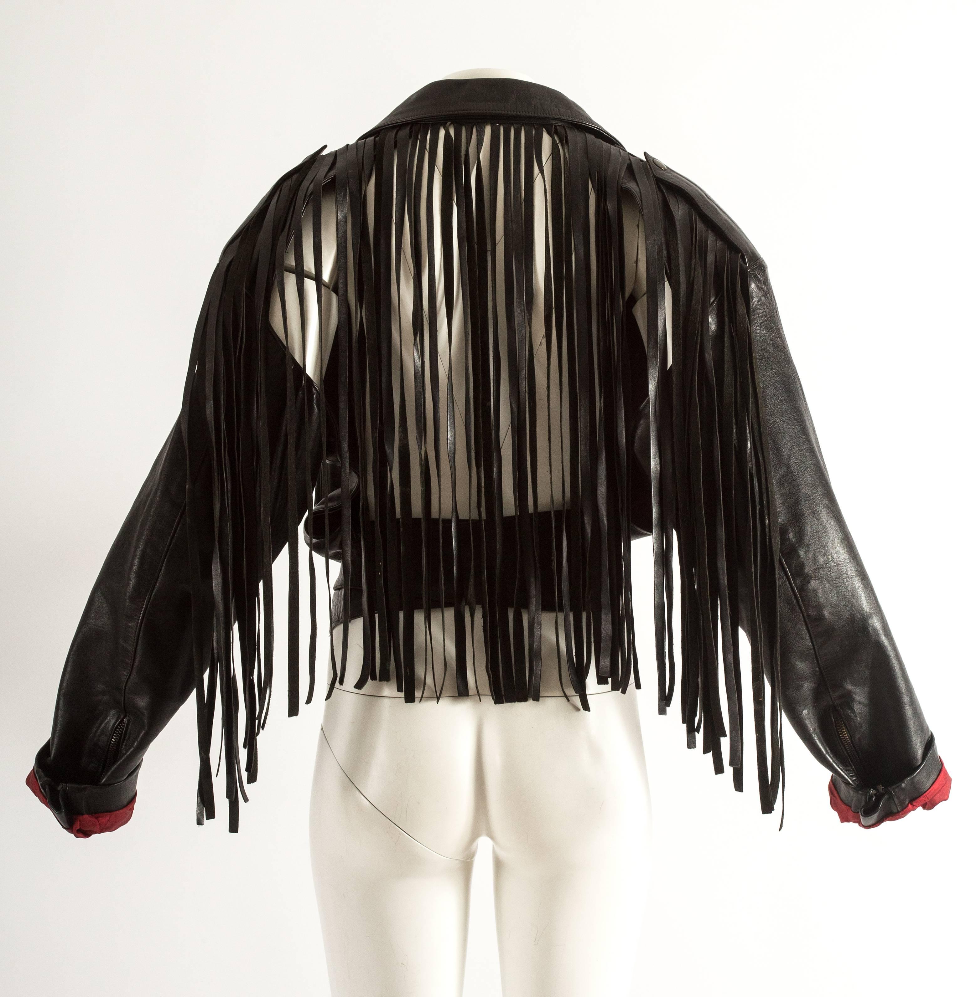 Jean Paul Gaultier Spring-Summer 1985 fringed leather jacket with open back and wrap belt fastening

Provenance: Pete Burns (Dead or Alive)