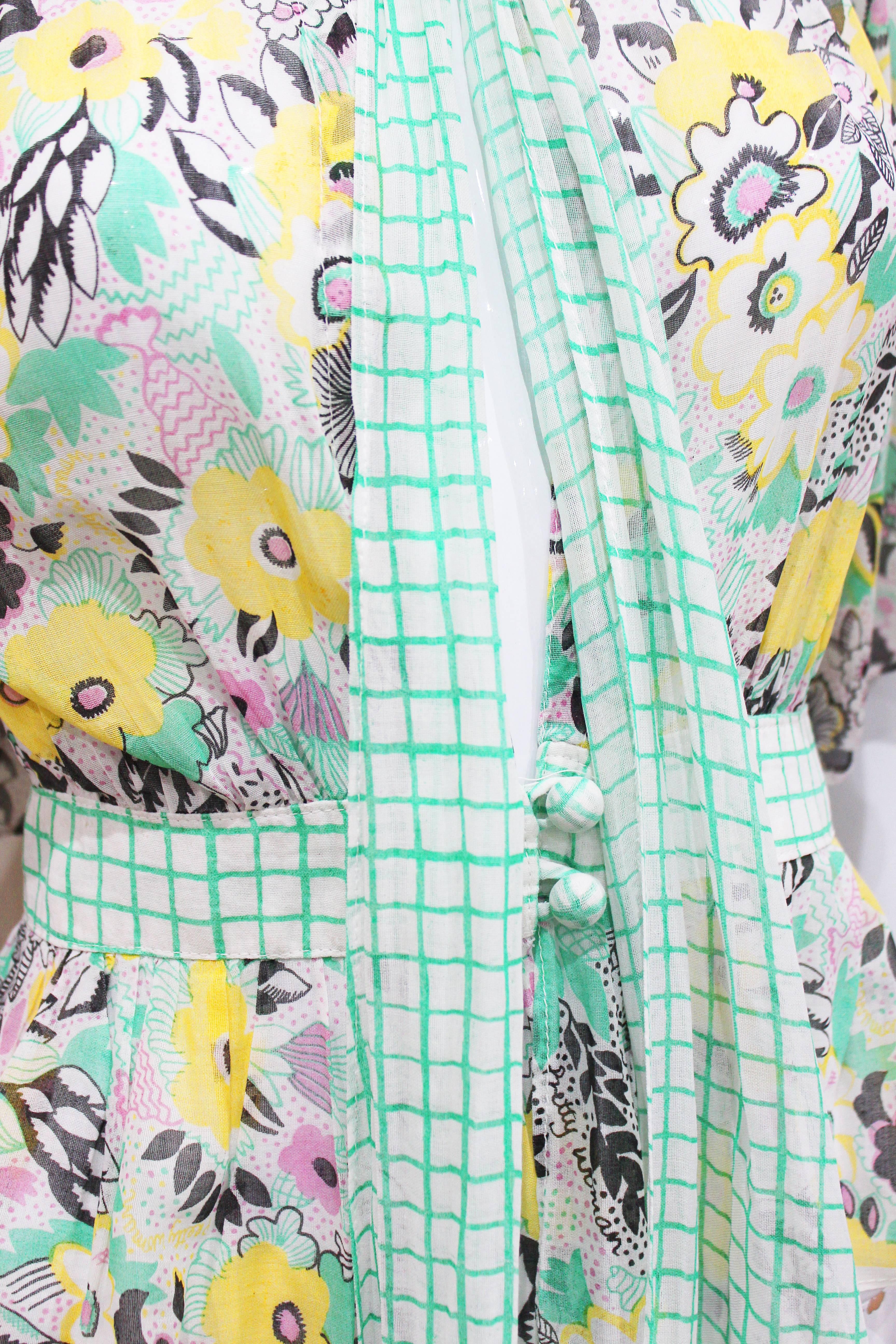 A fine and rare 1972 blouse by Ossie Clark with the 'Pretty Woman' print by textile and print designer Celia Birtwell. The blouse has a checked pussycat bow and waistband with two centred buttons, wide sleeves and a drop neckline.   

The print is