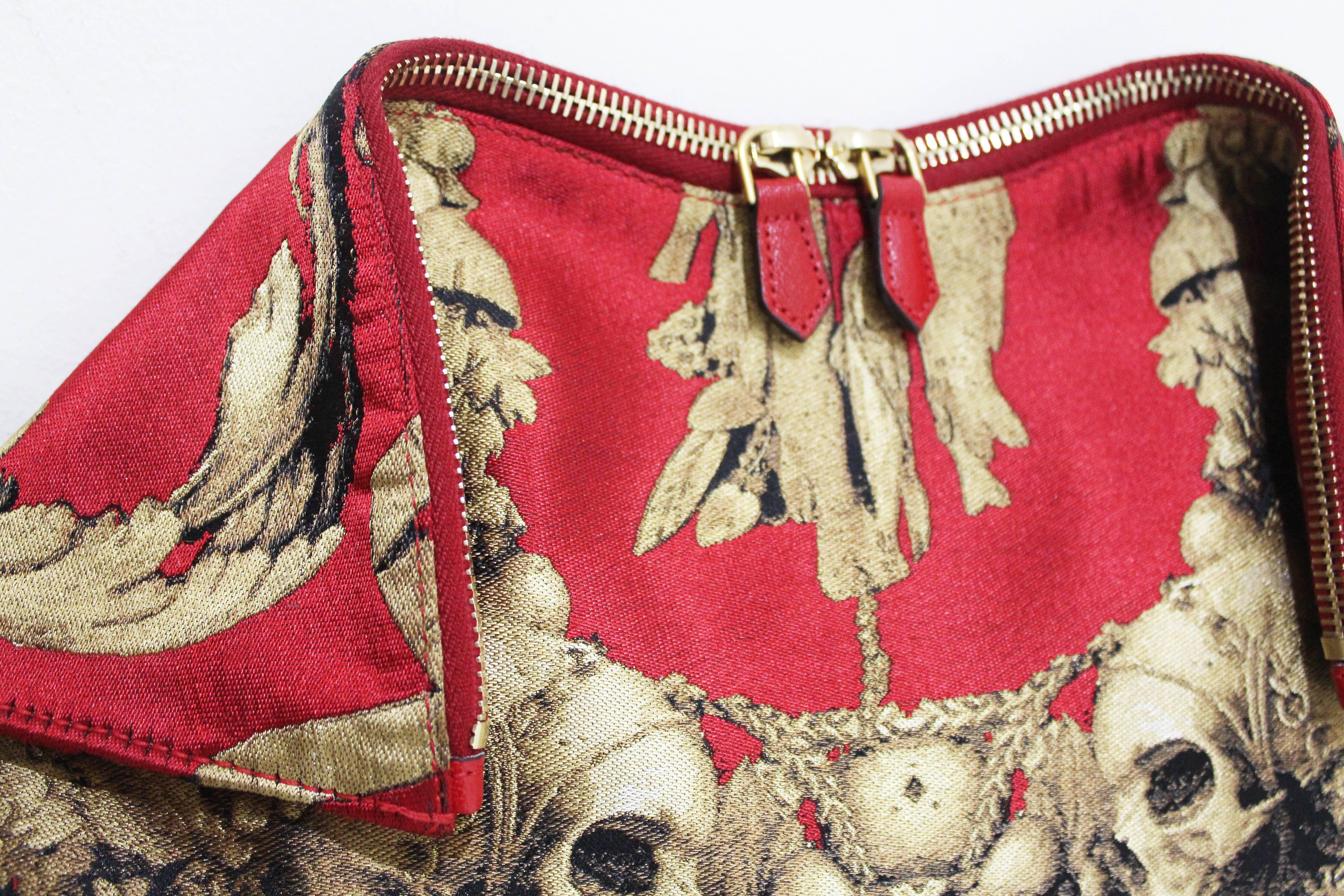 Autumn/Winter 2010 (Alexander McQueens last collection released after his death)

Red and gold Gibbons print clutch with quilted corners, gold double zipper top closure with magnetic fold over edges and inside zippered pocket.