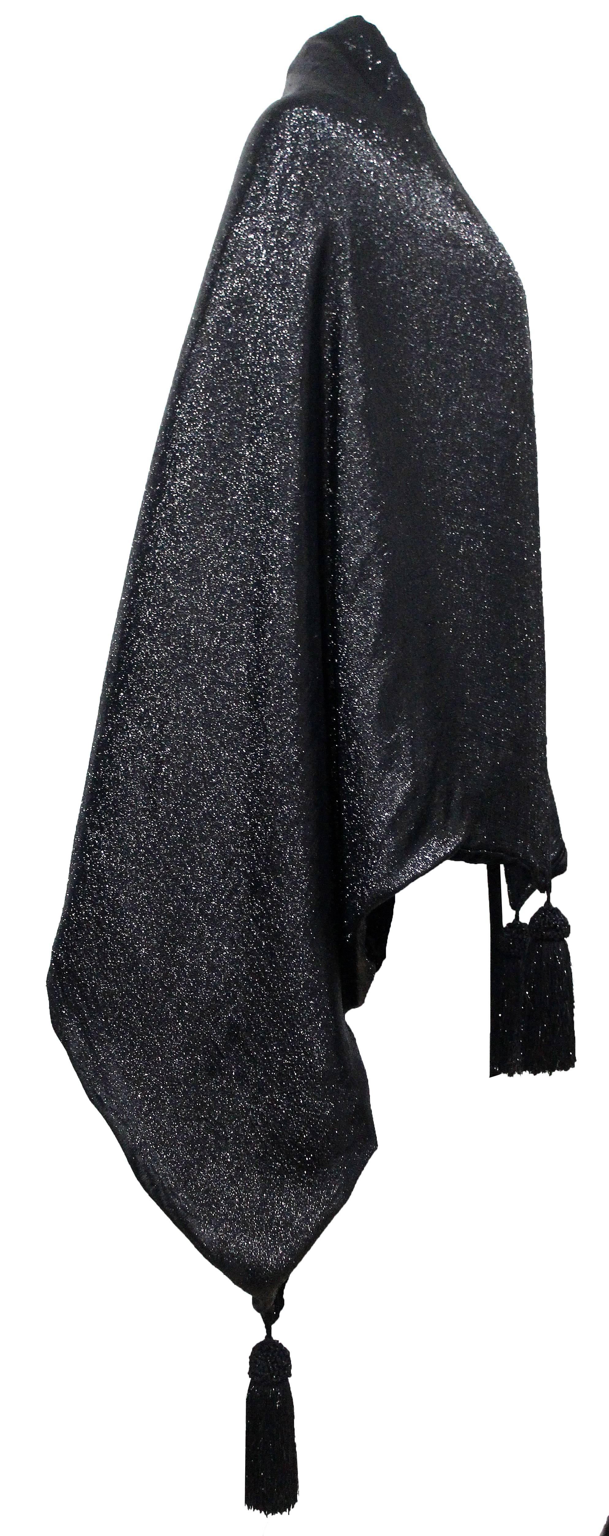 A luxurious large evening shawl by Gianfranco Ferre. The shawl has a metallic black and silver lurex exterior with a black velvet interior and four tassels on each corner. The shawl can be styled in many ways. 

Size: Approx. Length - 69 inches,