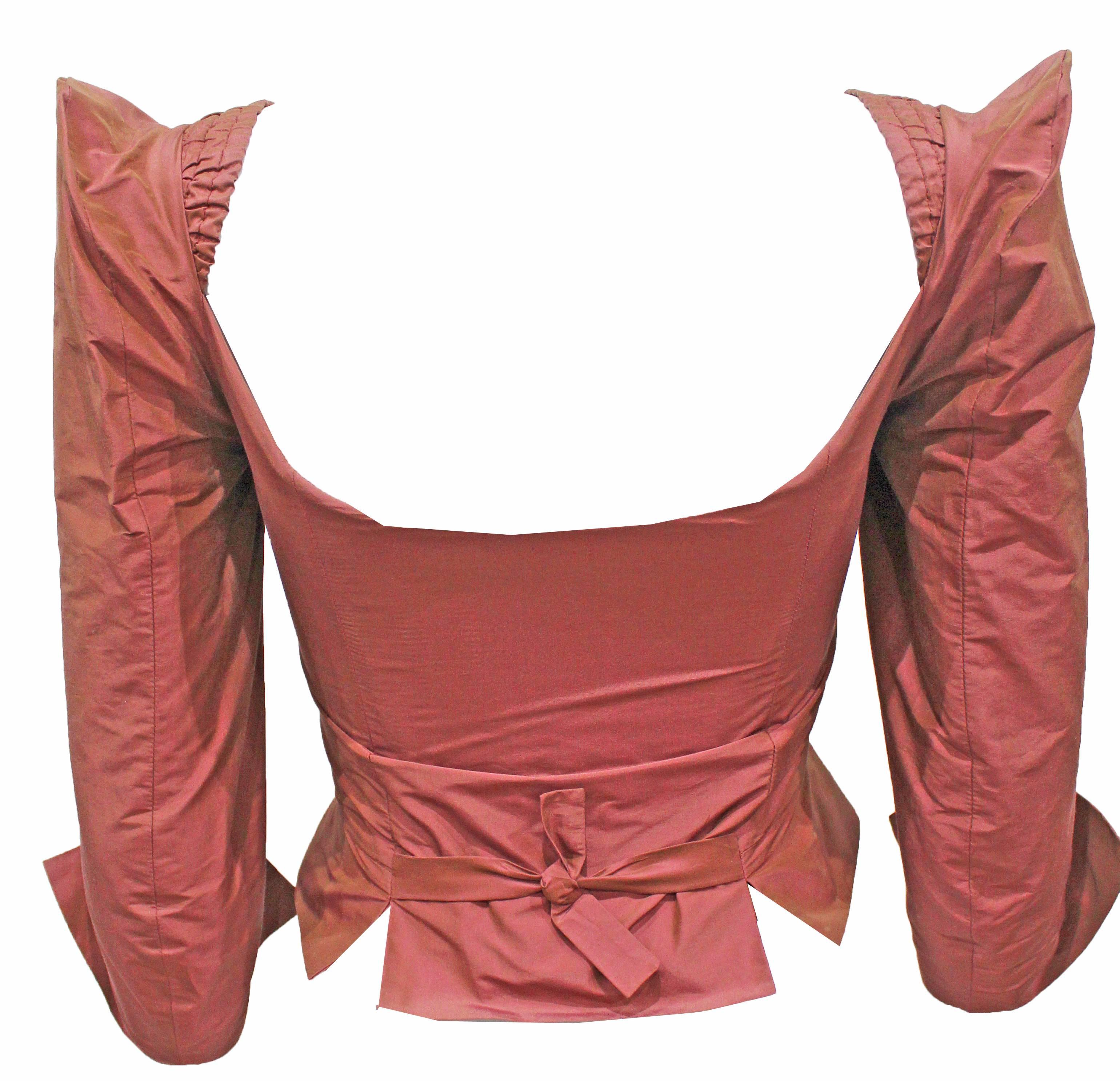 A rare rose pink Vivienne Westwood silk taffeta corset from the 1990s.

The corset is labelled a size UK 10, however the sizing runs very small and would be considered a UK 6-8 / US 2-4 / XS - Small