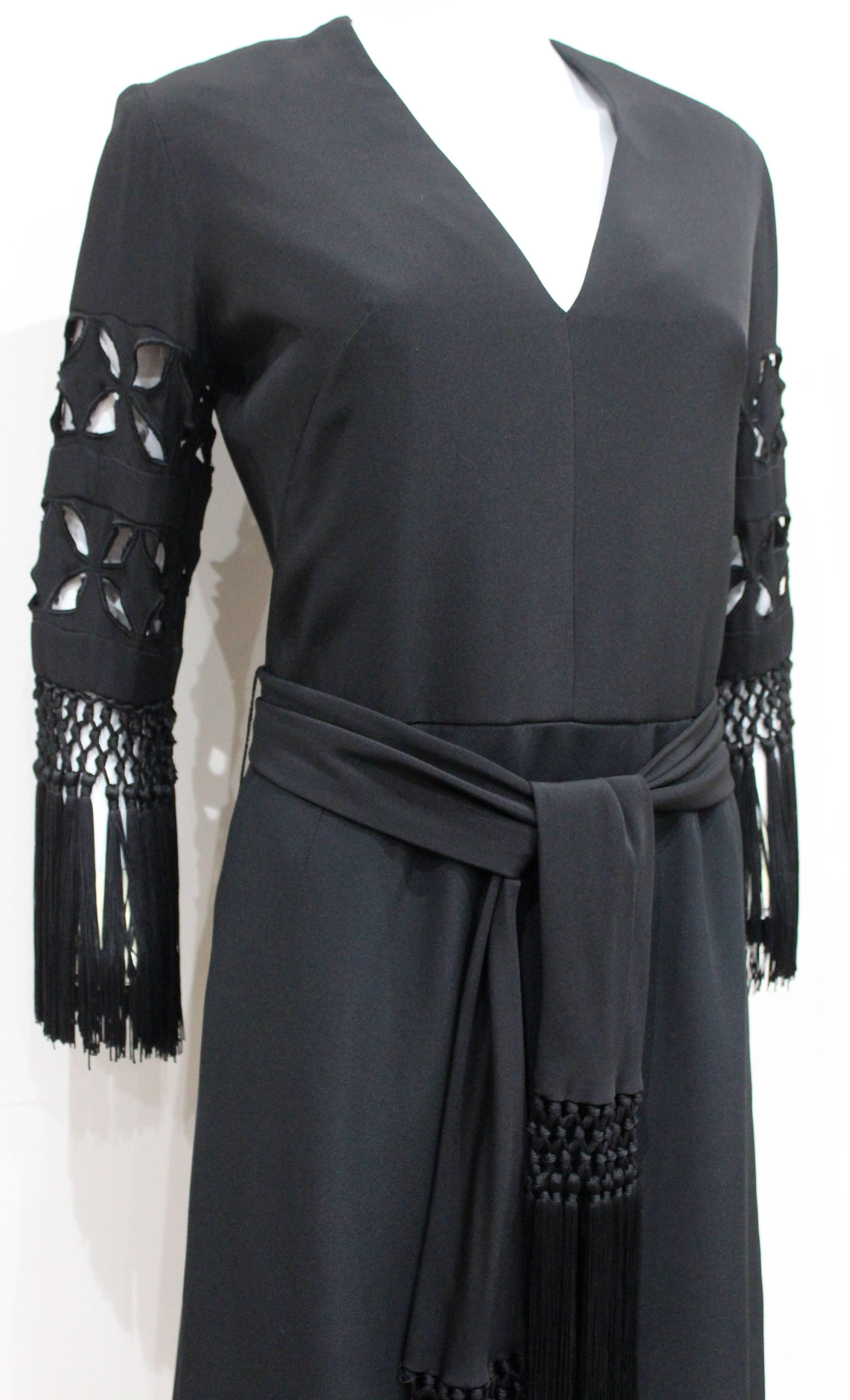 Rahvis, 19 Upper Grosvenor Street, London

1940s Black silk cocktail dress with cut out tasseled sleeves and matching tasseled waist belt. 

Approx. UK 10 - 12 / Fr 38 - 40

Pristine Condition
