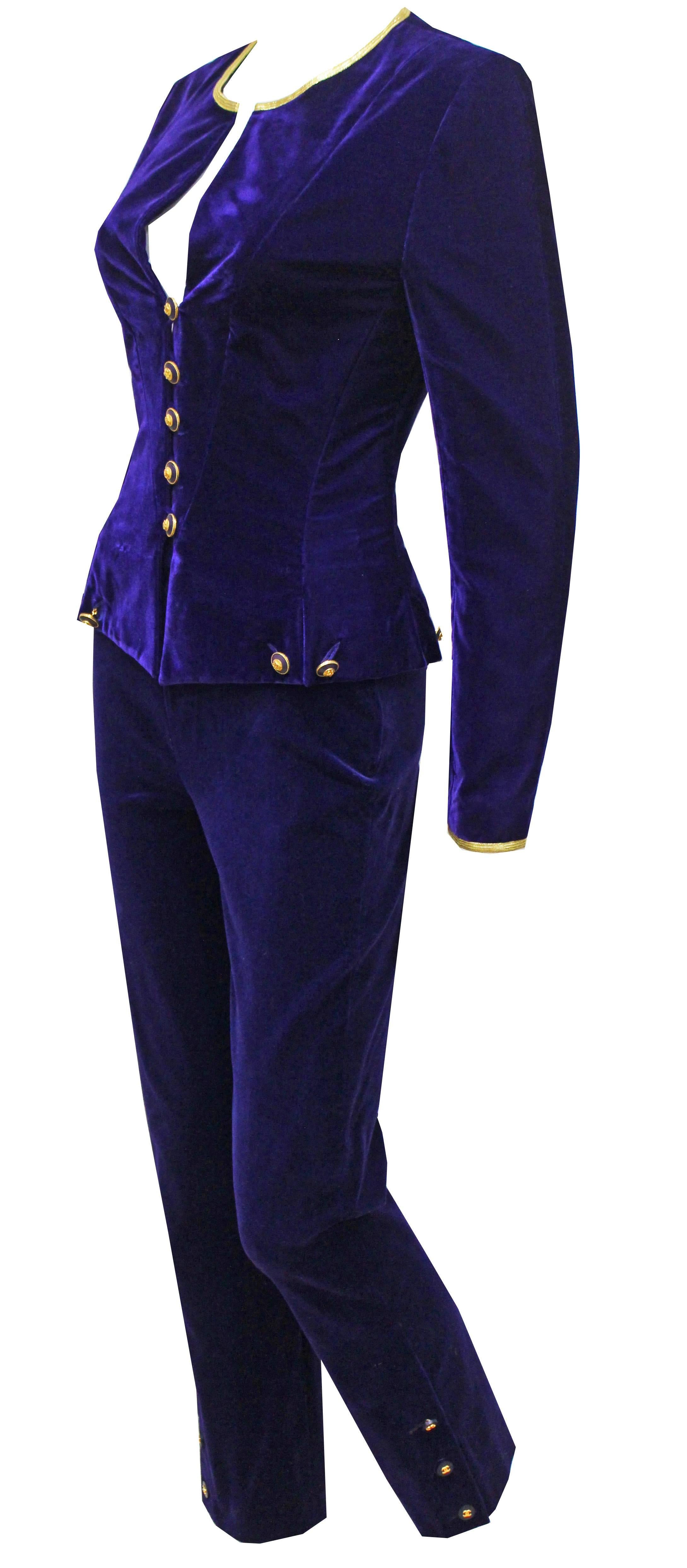 A fine and rare vintage Chanel velvet pant suit from the Autumn/Winter 1993 collection. The suit consists of a tailored velvet jacket with round neckline, long fitted sleeves, 5 gold 'CC' button closures running through centre, 4 sets of chain