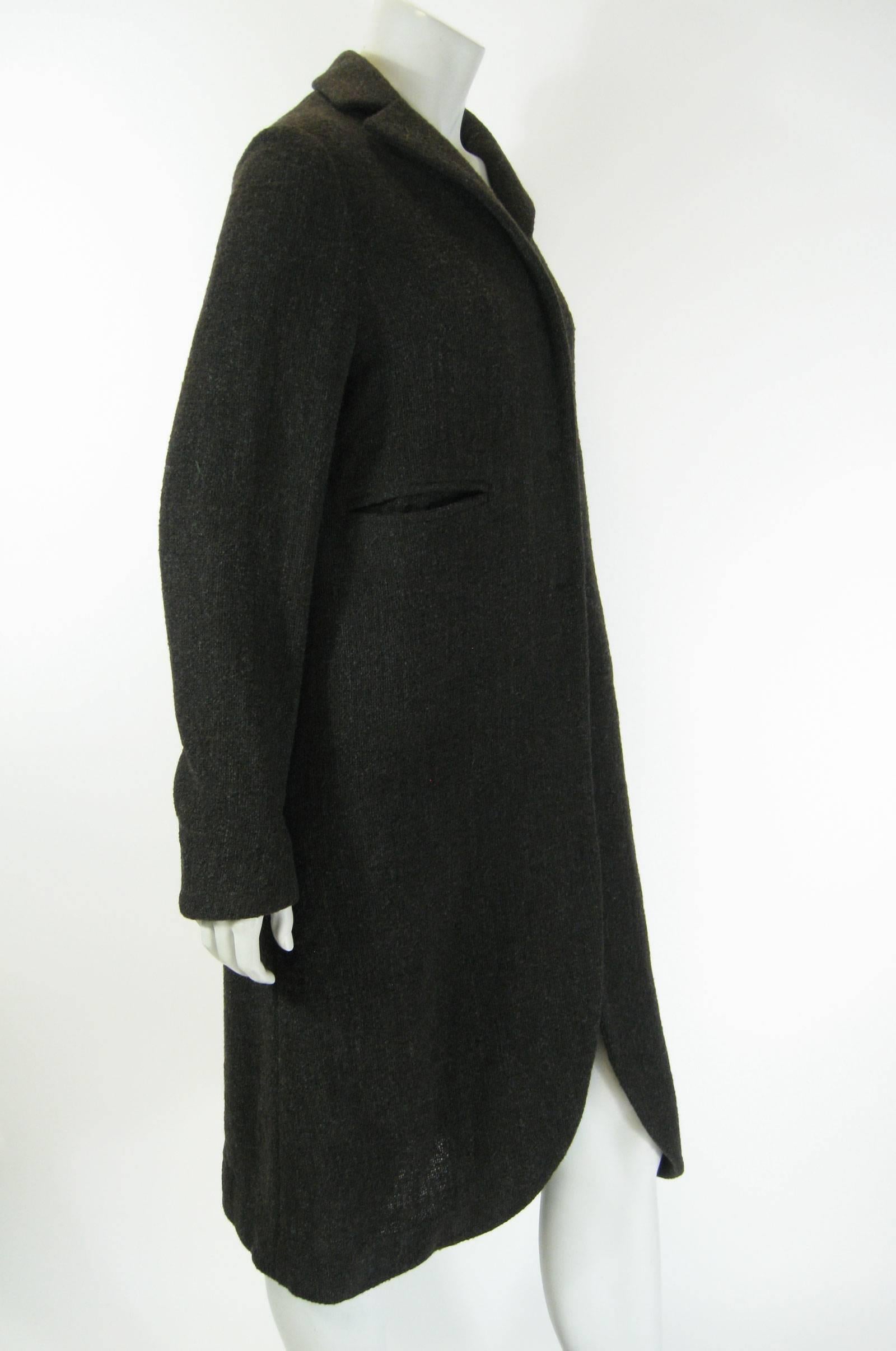 Marni long structured sweater coat.
Dark gray/brown, aka taupe.
Hidden button closure.
Slit pockets.
Slightly rounded peek-a boo hem.
No lining.
Tagged a size 42.

Bust: 40