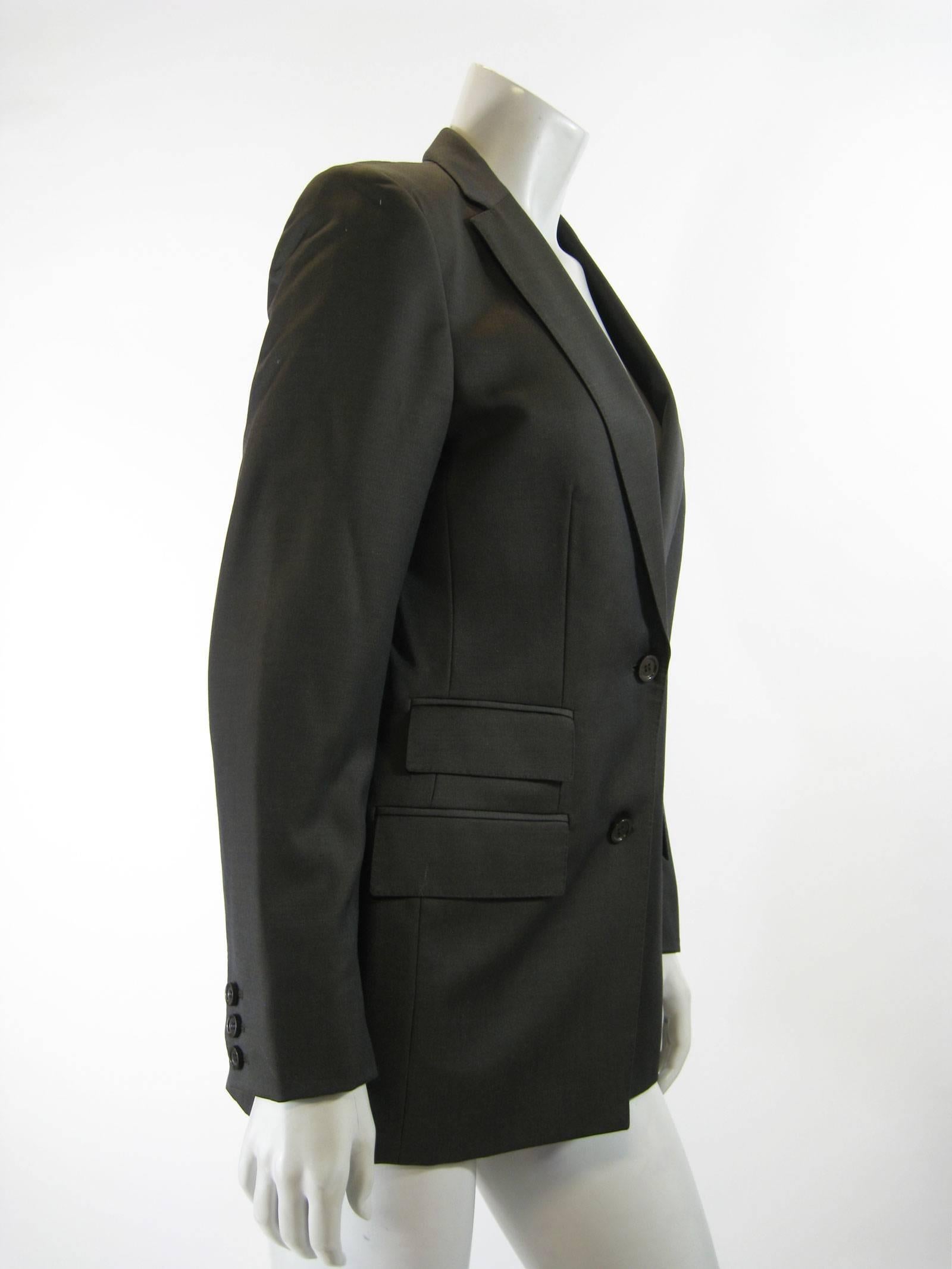 Menswear-inspired Gucci tailored jacket.
Chest pocket, two slant pockets on  right hip, one left.
Two button closure.
Three button detailing on cuffs.
Lined.
Tagged a size 40.

Chest: 34