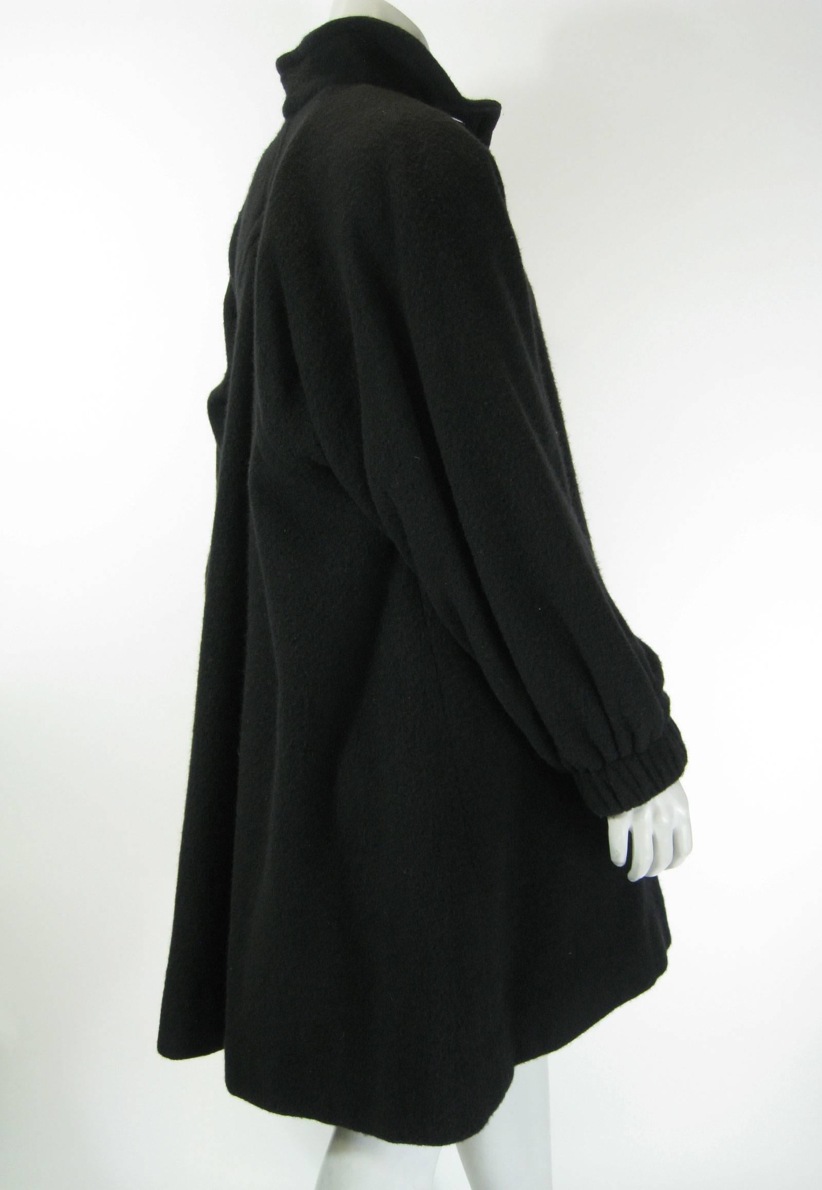 Vintage YSL Rive Gauche black coat.
Oversized a-line swing style.
Oversize buttons.
Fuzzy texture, feels like wool blend.
Elasticized cuffs, sleeves slightly ballooned.
Side slit pockets.
Fully lined.
No size tag found.

Chest: 50