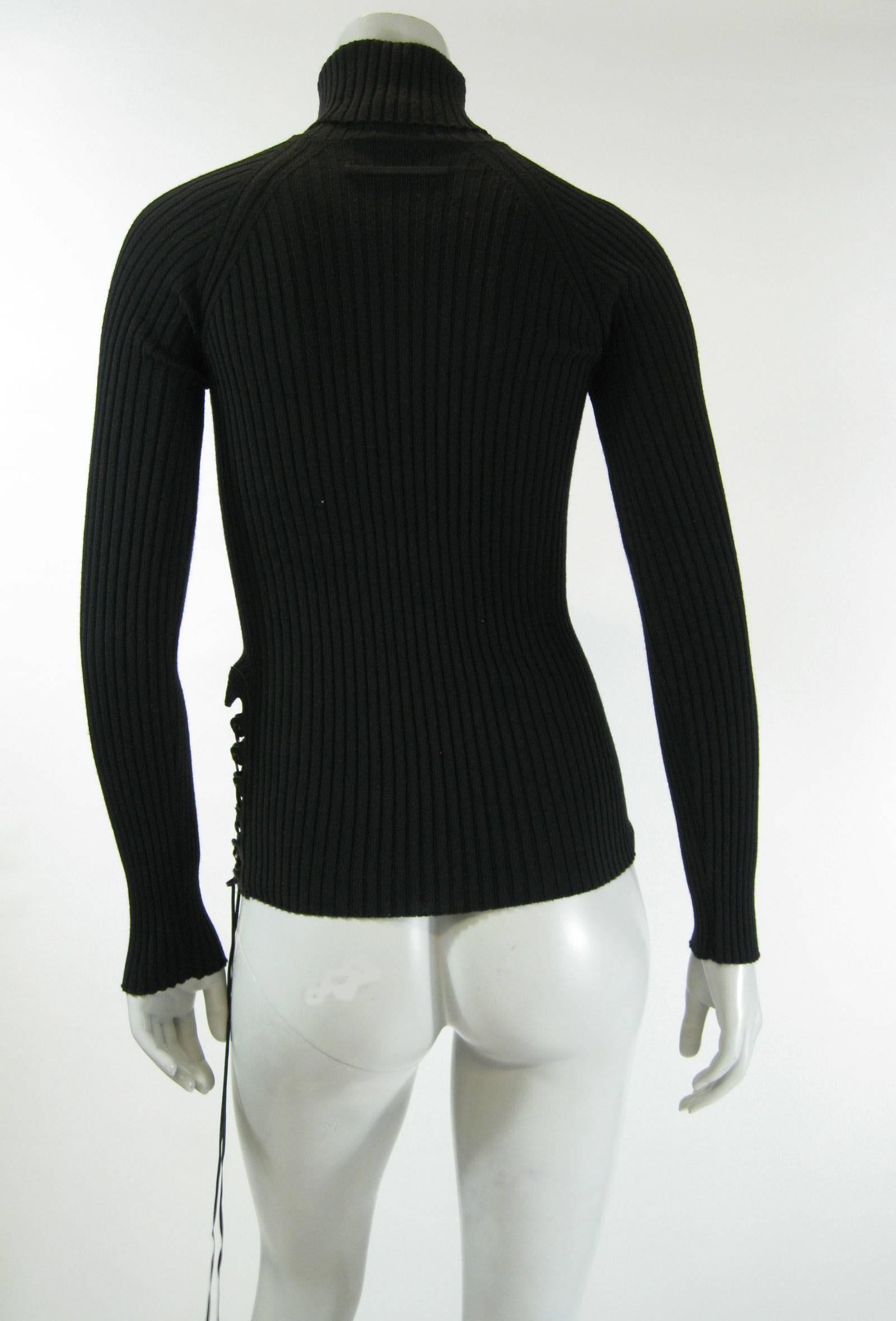 Black Gaultier rib knit sweater.
Sung fitted, stretchy.
Pony hair and leather side corseting.
Tagged a size Small.

Measurements taken flat, will stretch.
Bust: 20