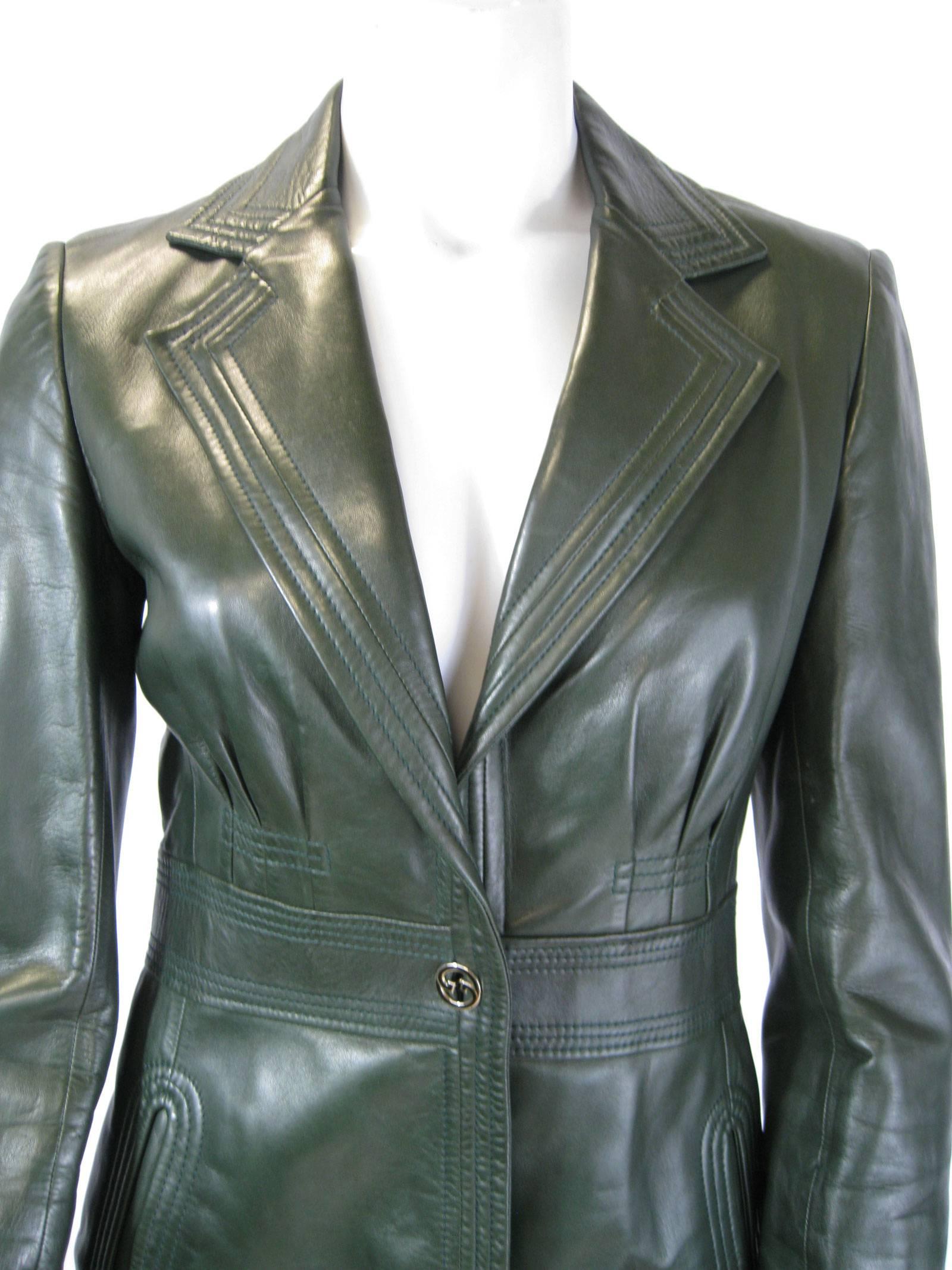 Incredibly soft, supple Gucci leather jacket.
Deep forest green.
Pleating detail on chest.
Wide stitched waistband..
Stitch detailing on collars.
One decorative button closure, and button cuffs.
Side hip pockets.
Lined.

Chest:  36