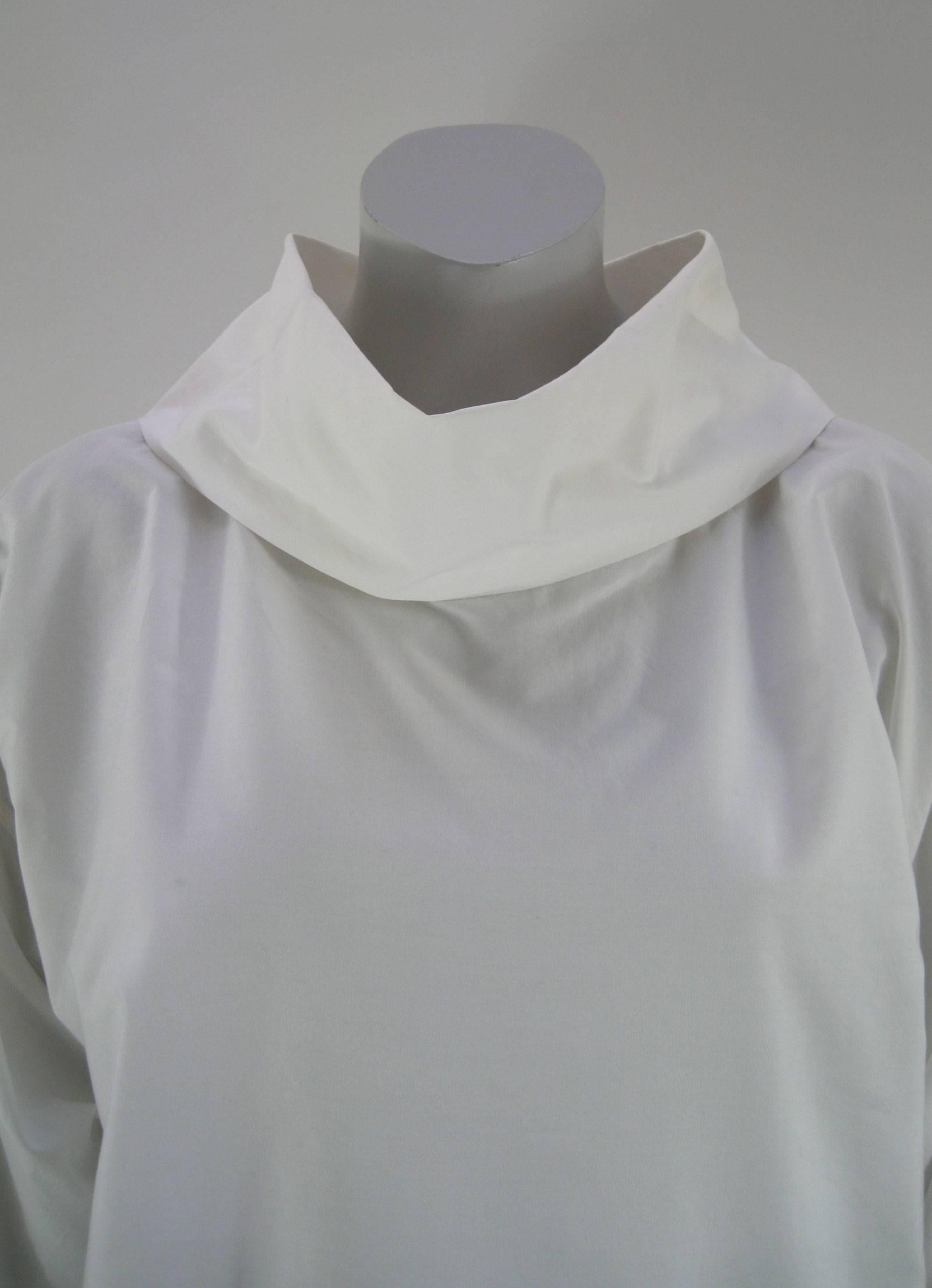 Crisp white cotton Issey Miyake Plantation shirt.
Loose fitting, unisex.
Pull over. No closures.
Long loose sleeve.
Large slouchy collar can be worn folded or straight.
No size tag found. 

