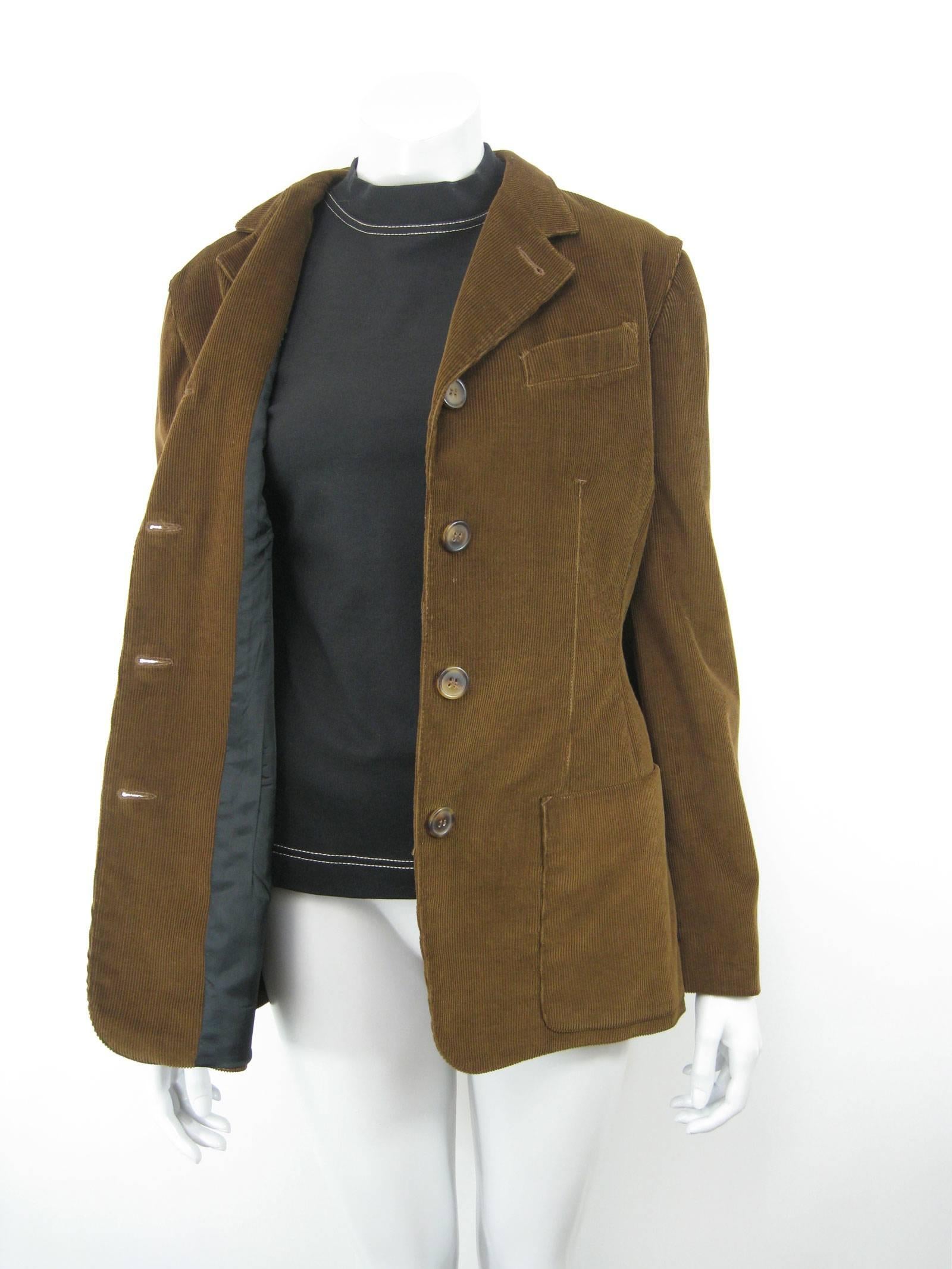 Vintage Jean-Paul Gaultier jacket/shirt/vest 2 piece.
Dark cinnamon-brown corduroy. 
Sleeves attached to a high-neck black stretch shirt.
Vest is separate piece (both can be worn separately). 
Vest has five tortoise shell buttons, two outside