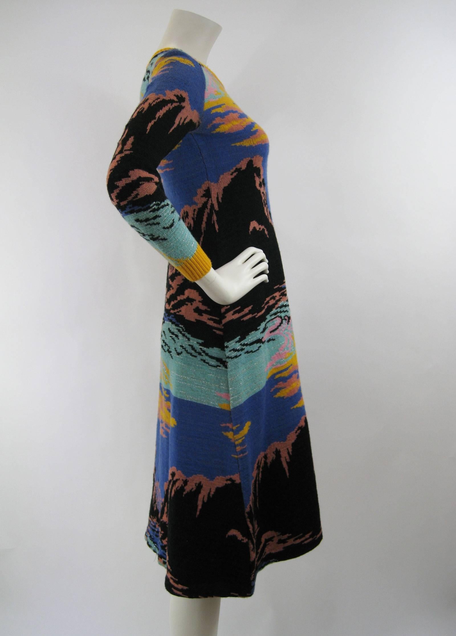 Stunning Alley Cat sweater dress by Betsey Johnson.
Circa 1970's.
Vibrant sunset hues.
Hourglass shape.
Mid calf length.
Ribbed trim
Soft wool. There is a fair amount of stretch in the dress.
Unlined.
No tagged size .

This is in good pre-owned