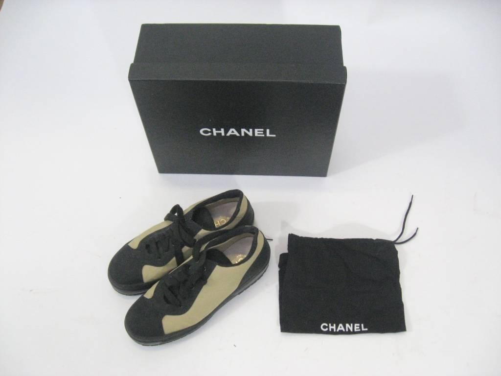 Authentic Chanel low top sneakers.

Off-white canvas & black nylon.

Black laces.

Padded tongue and heel.

Chanel stamp on heel.

Marked a size 39.

These come with the original box and dust bag.

These are in excellent condition,