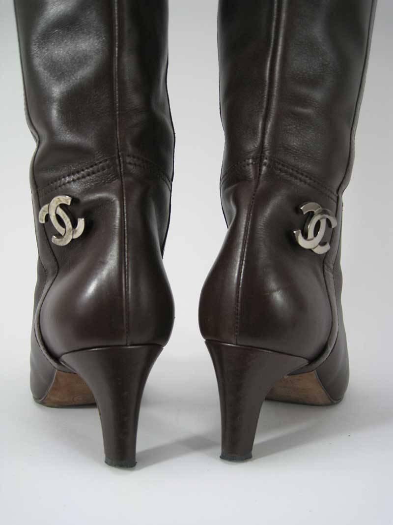 Chanel boots in brown leather with black accent at the toe box. There is a metal CC logo on the heel. 

These are in good pre-owned condition, these do show signs of wear. Please note the wear on the front in the last photo.

These are made in