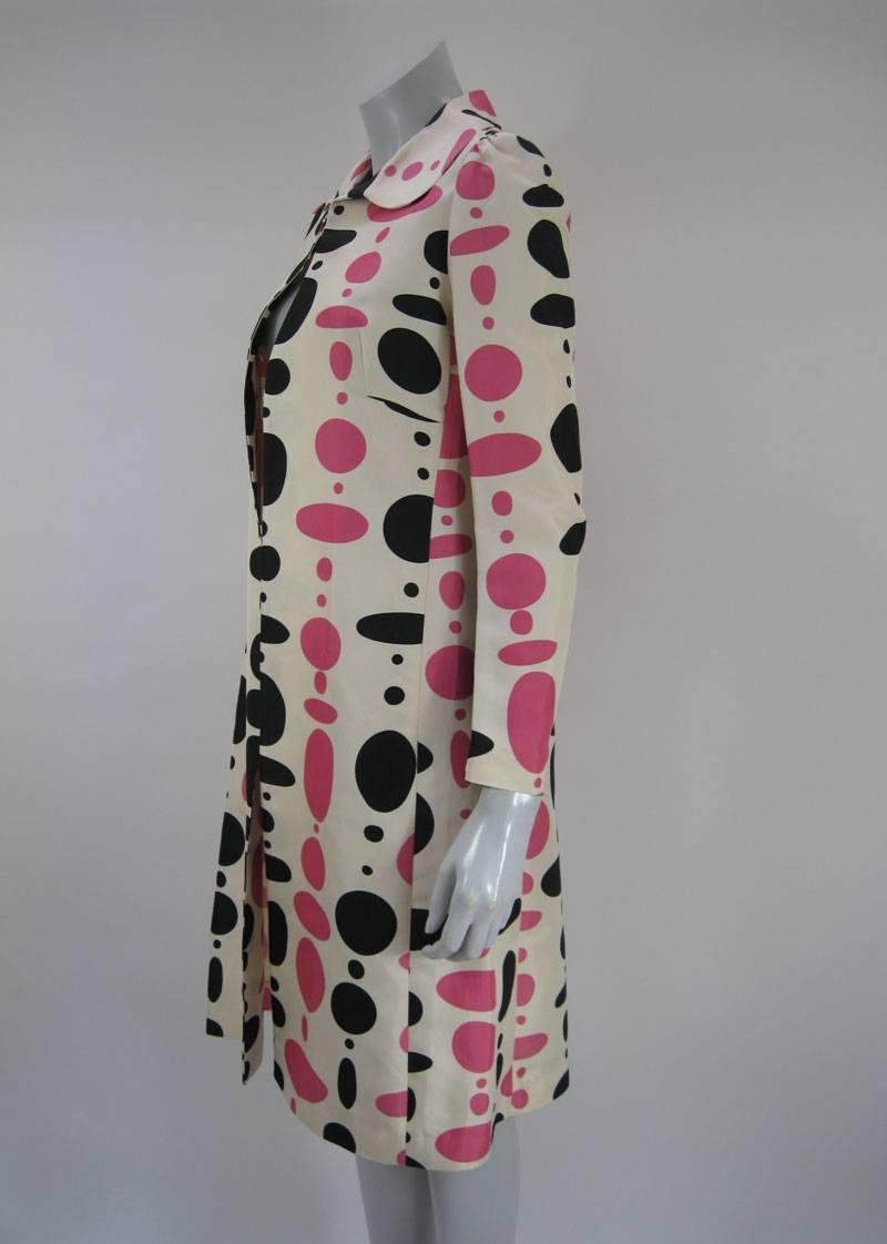Polka dot patterned coat by Marni in shades of creme, pink and black.

No fasteners.
Knee length.

Cotton and Silk. 
Made in Italy.

Tagged a size 42.

This is in excellent pre-owned condition. Please note the light spot at the back of the collar.