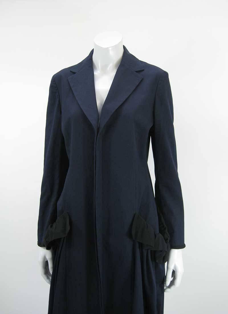 Dark navy blue coat with lovely draping and oversize front pouch pockets by Yohji Yamamoto, +Noir collection.

Mid calf length.

Cotton and Silk. 

Made in Japan.

Tagged a size 2.

This is in excellent pre-owned condition with no holes, stains or