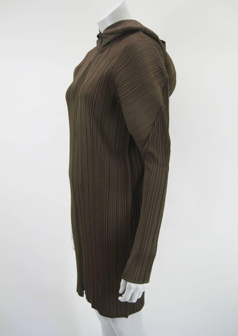 Hooded coat, full front zipper, in burnt umber by Issey Miyake from the Pleats Please collection.

Mid calf length.

100% Polyester.

Tagged a size 4.

There is a significant amount of stretch in the fabric.

This is in excellent pre-owned condition