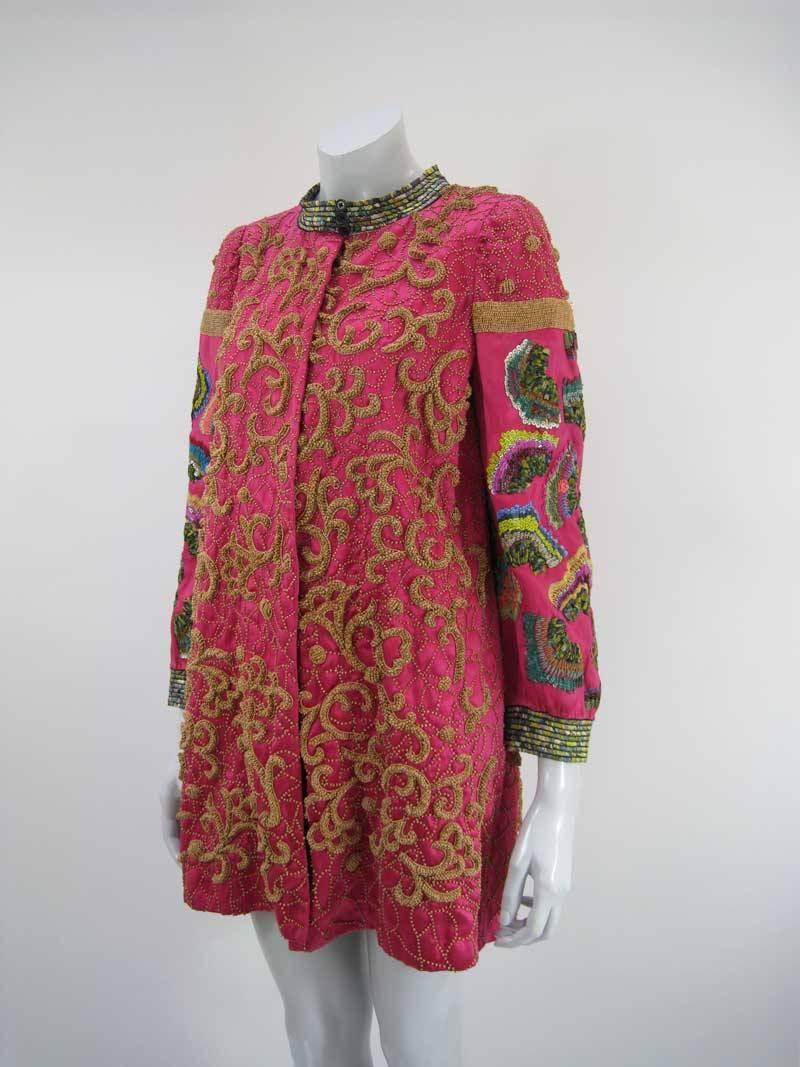 An extraordinary jacket from the Dries Van Noten Ready-to-Wear Fall 2008 collection.

Silk in a hot pink color with incredible embellishing.

Above the knee.

Silk, cotton and metal fibre.

Tagged a size 40.

This is in excellent pre-owned condition