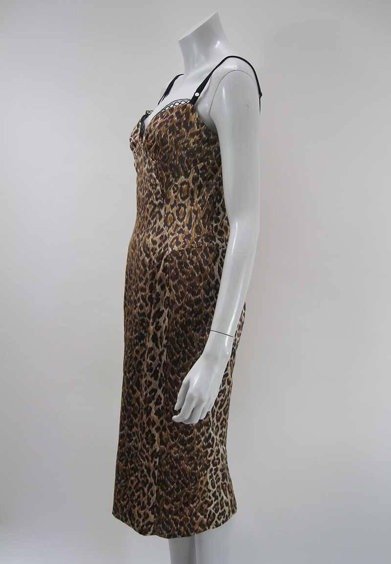 Dolce and Gabbana stretchy satin leopard print dress.

Lace trim detail at bust.

Adjustable lingerie straps.

Empire waist.

Hits at knee with back vent.

Back zipper.

Made of cotton and rayon and other fibers.

Tagged a size 44.

There is a