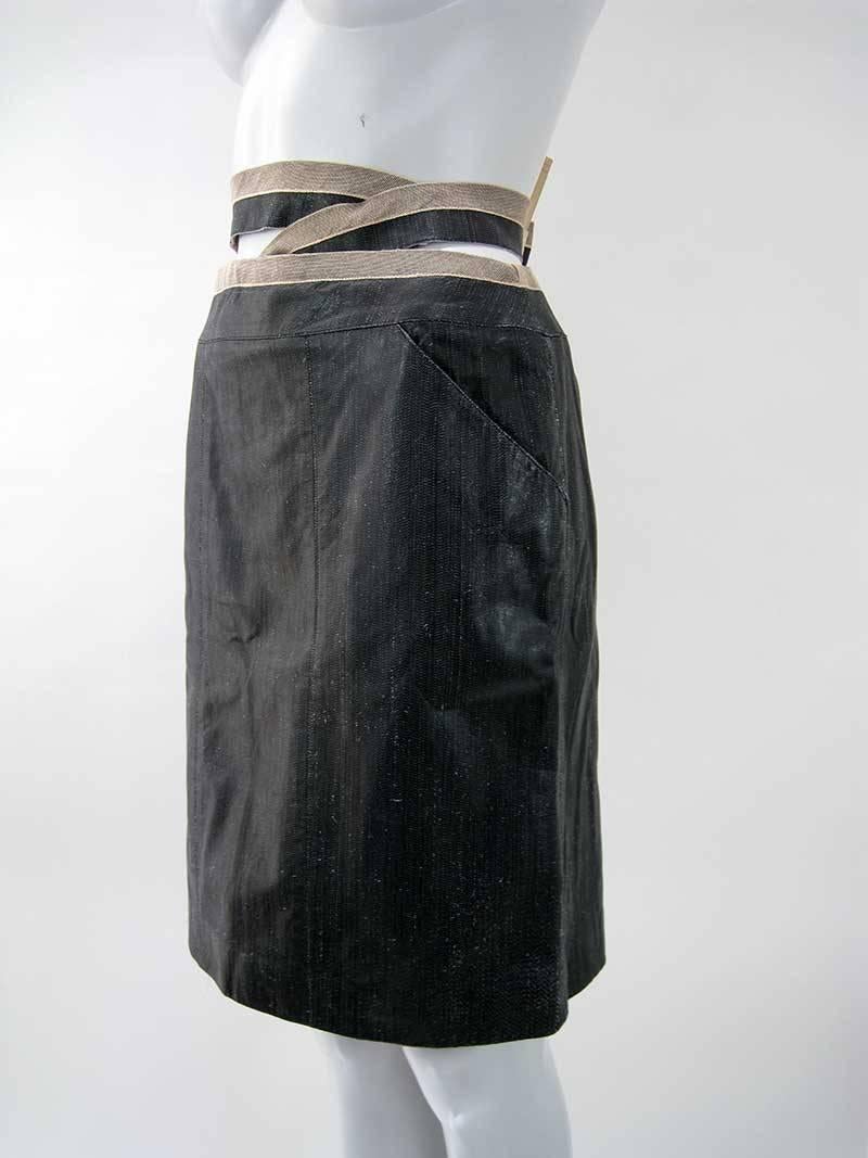 Elegant textured Chanel calf skin skirt.

Soft black/gray with faux snake skin appearance.

Wrap around waist with button closure.

Straight fit with back zipper.

Two front hip pockets.

Calf skin outer, lined in silk.

Tagged a size 40.

This is