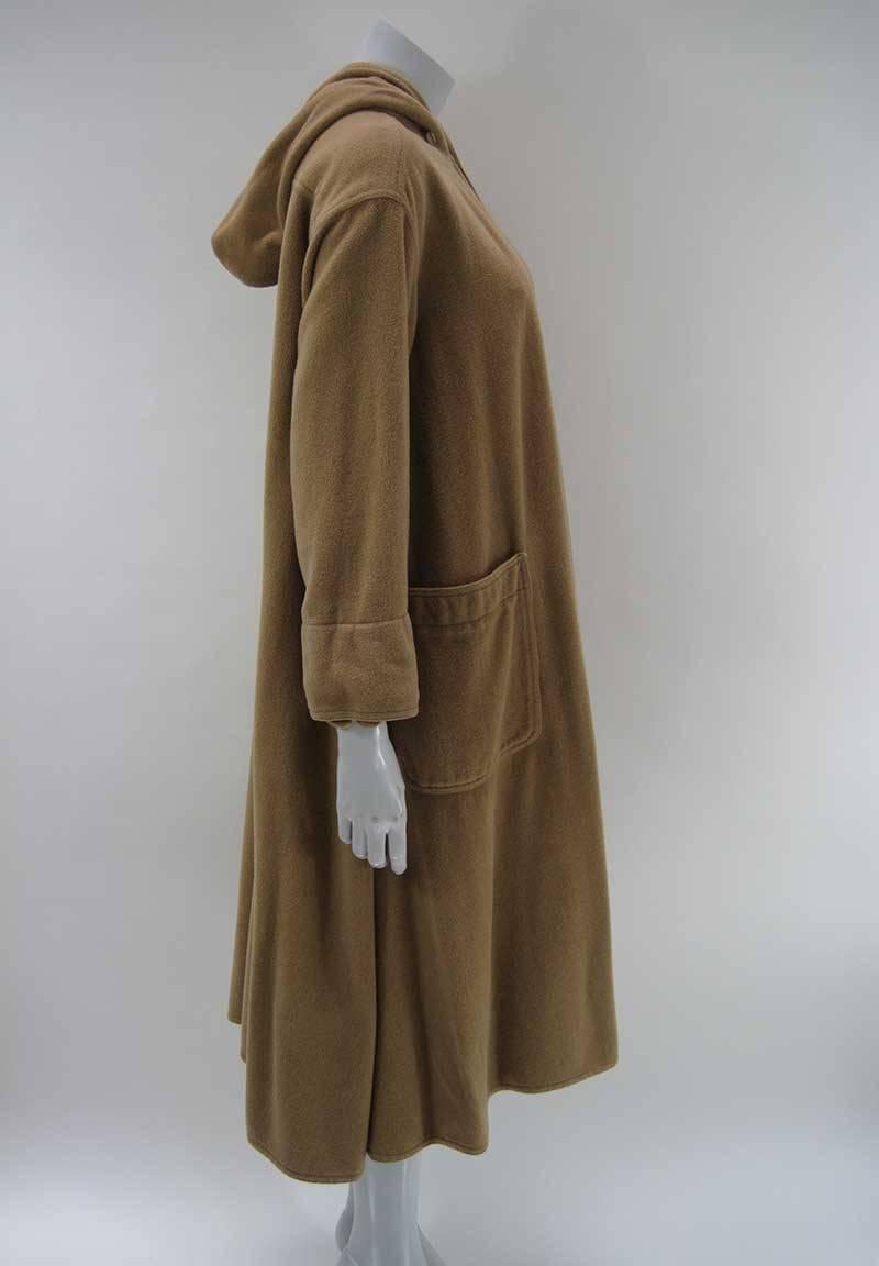 Rare vintage Kenzo open fleece wrap/jacket, almost like a cloak.

Soft tan camel color. 

Oversize hood. 

Two front bucket pockets.

Hook and eye closure at neck.

Soft fleece fabric, content unknown. 

No size tag.

This is in good pre-owned
