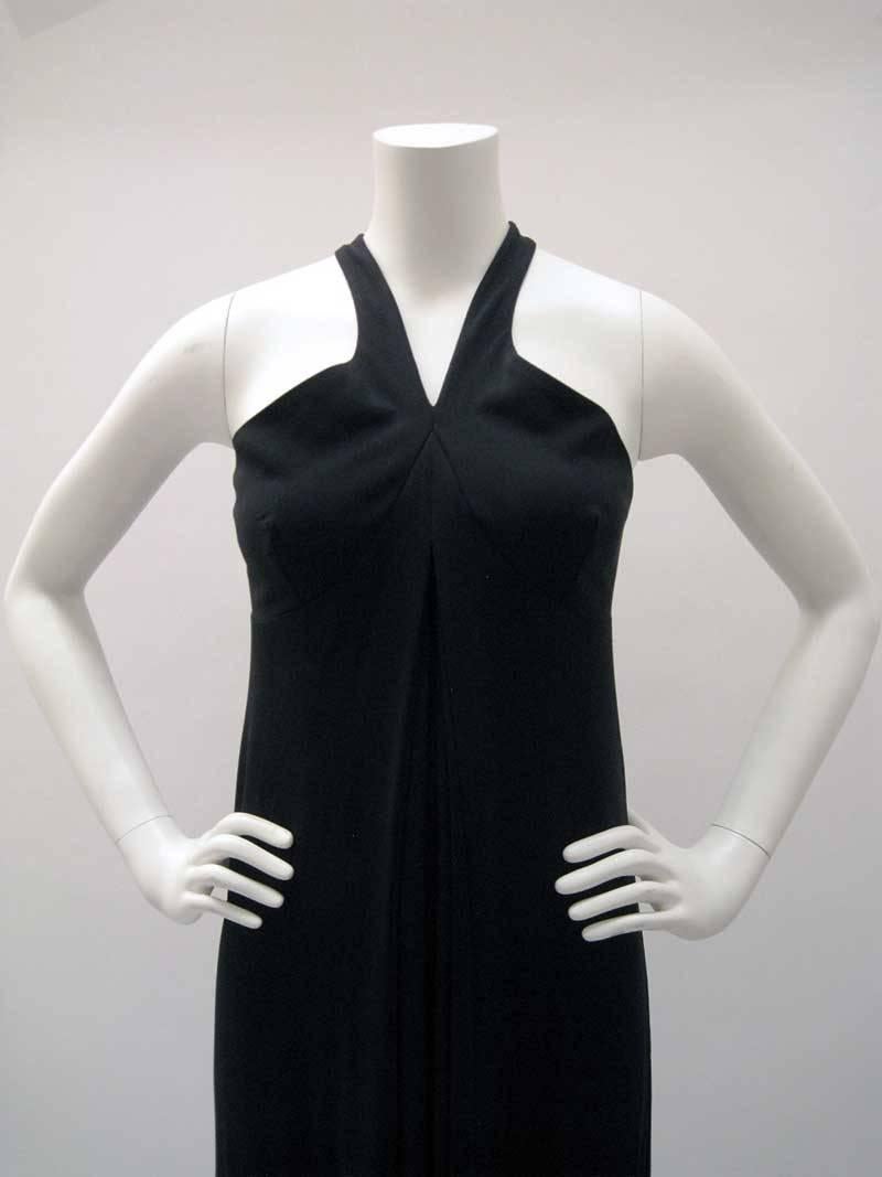 Classic Gianfranco Ferre long black dress.

Empire waist with open back and criss cross straps.

Inverted pleat with full skirt.

Back zipper.

No fabric content tag, jersey material with stretch.

No size tag.

This is in excellent pre-owned