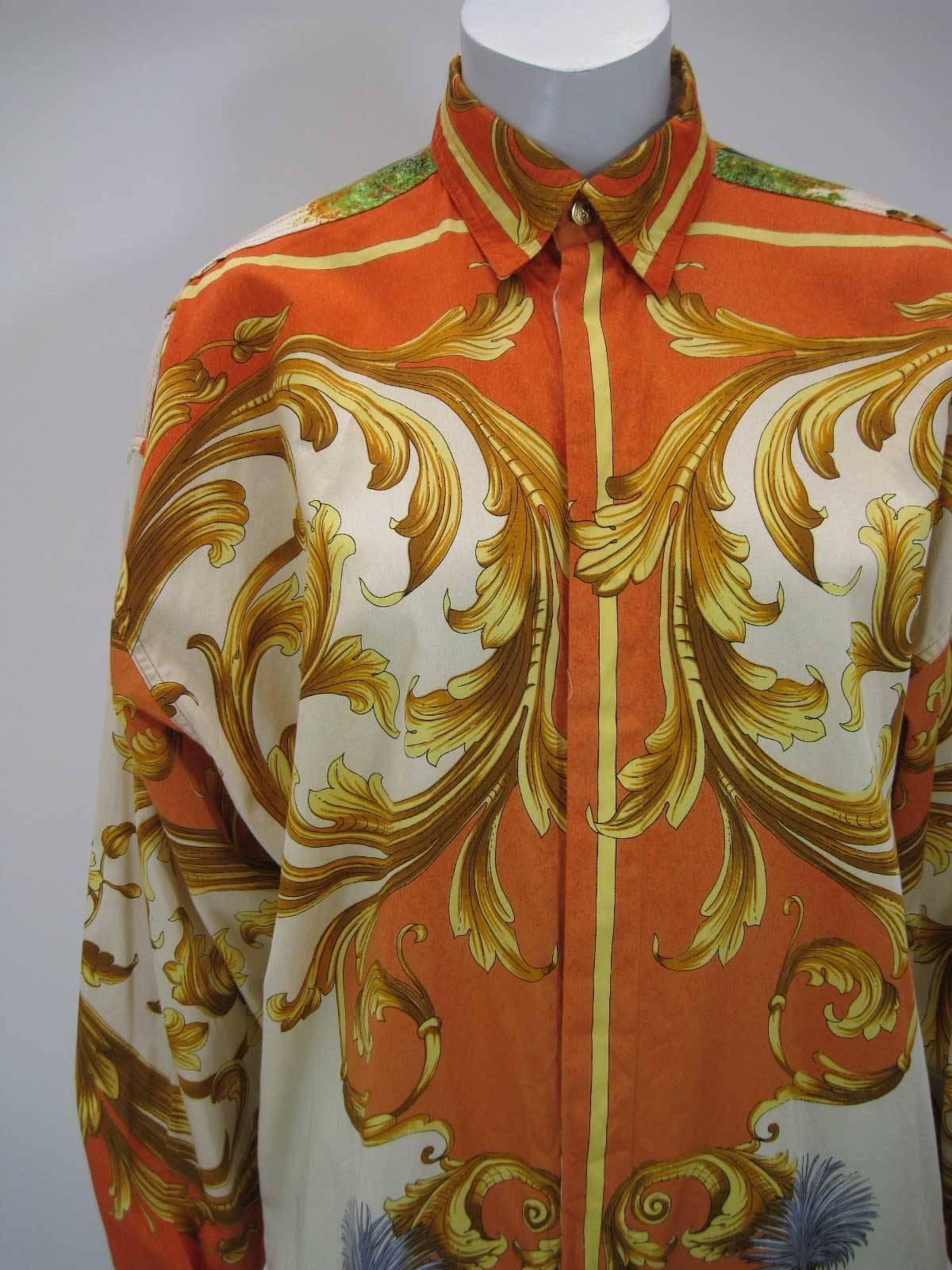 Striking Versus Gianni Versace button down shirt.

Baroque print of birds, bucks and a large goddess on the back.

Vibrant hues of burnt orange, yellow, gold and more.

Button down collar.

Hidden button placket.

Fabric is cotton.

Button