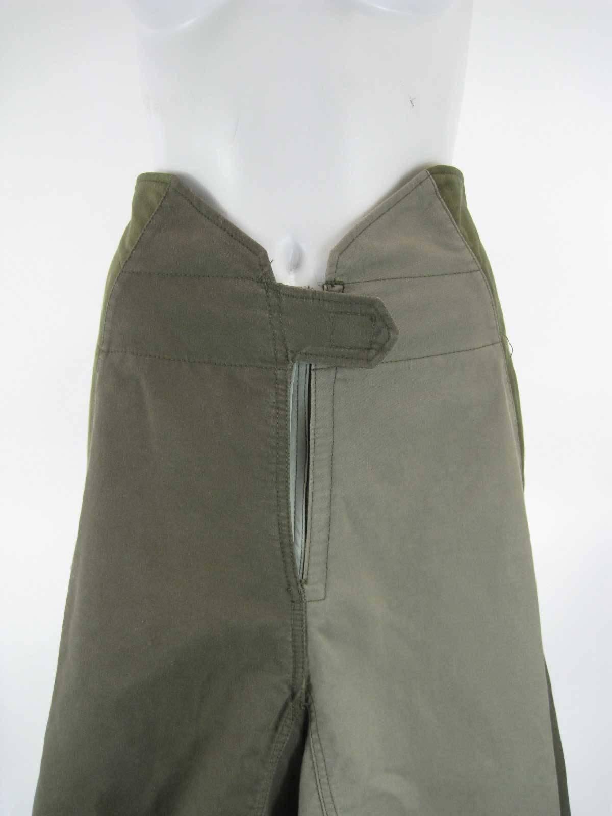 2006 Junya Watanabe for Comme des Garcons military skirt.

Skirt has tulip shape, slightly asymmetrical.

Made of patched pieced of structured mid-heavier weight cotton.

Different hues of olive drab/army green.

Front zipper. Velcro panels on