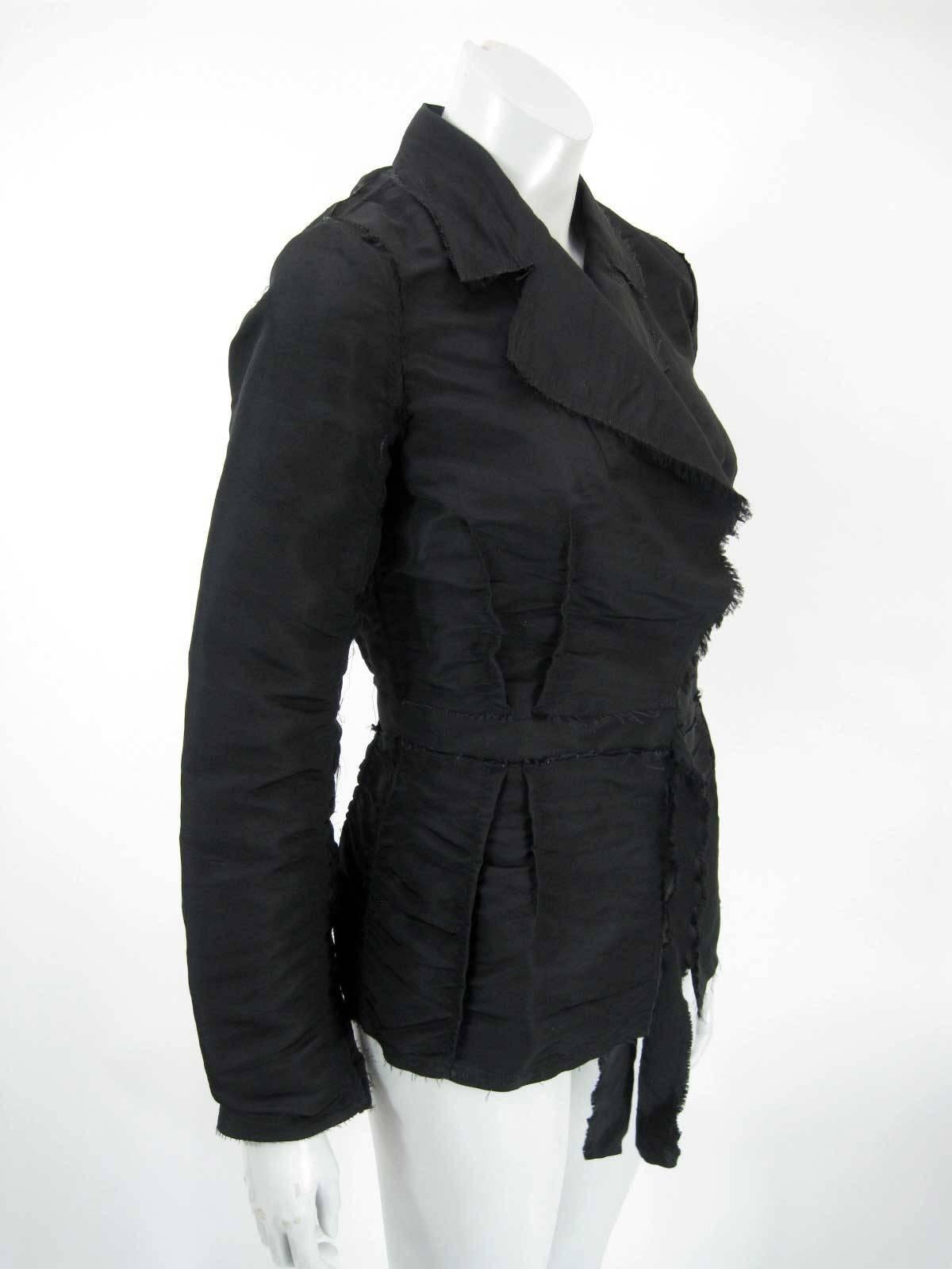 2005 Lanvin black silk wrap jacket.

Textured, ruched and pintucked silk.

Frayed hems.

Hook and eye closure and frayed self tie at waist.

Tagged size 38.

Fabric is silk.

This is in excellent pre-owned condition with no holes, stains or