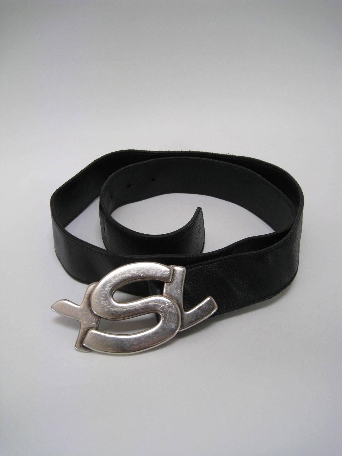 Large YSL logo belt buckle and belt.

Heavier weight silver tone metal YSL buckle.

Wide black pebbled leather belt.

Marked size 40.

Made in Italy.

This item is in good pre-owned condition with wear to belt that can be see in images. Leather has