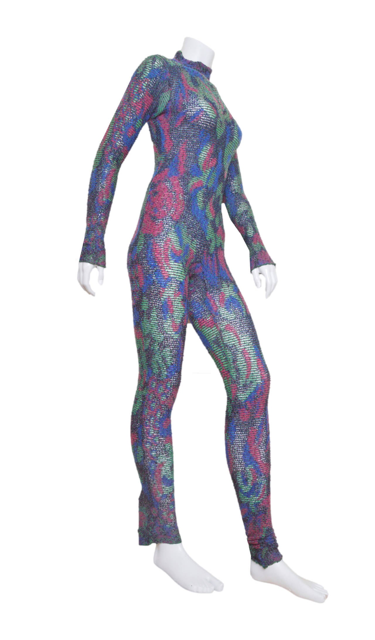 Outstanding Missoni bodysuit.
Jewel tones, emerald green, raspberry, cobalt blue & black.
Somewhat open weave, slightly sheer.
Mock turtleneck with shirring.
Shirring at wrists and ankles.
Back zipper.
Tagged size 42.
Measurements were taken