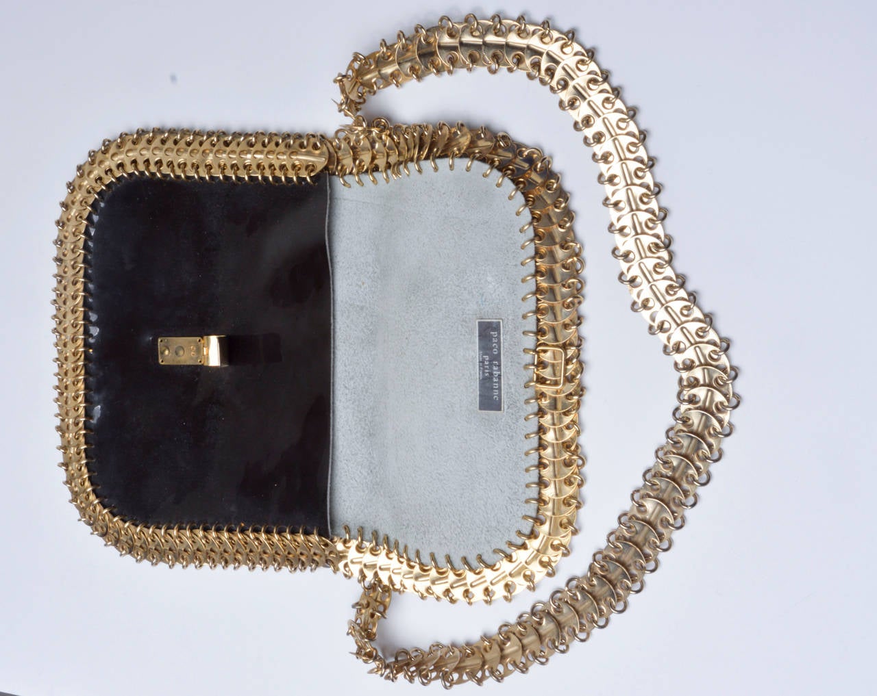 Iconic 1960's Paco Rabanne purse in chocolate brown patent leather.
Gold metal chain link strap and trim.
Fold over clasp.