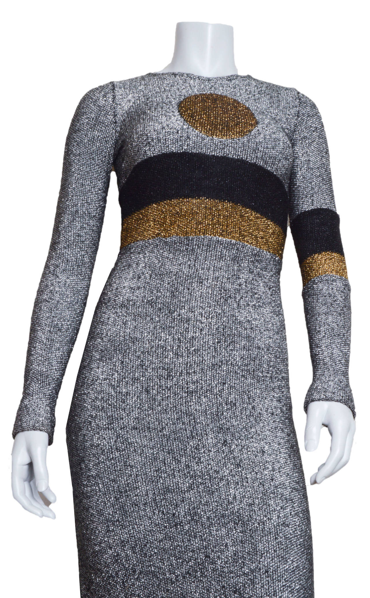 Op Art Rudi Gernreich for Harmon Knitwear gown.
Form fitting, stretchy silhouette.
Silver metallic thread with gold dot on chest.
Waist cinching black and gold stripes with matching armband.
Back zipper.
Unlined.
Tagged a size 8.