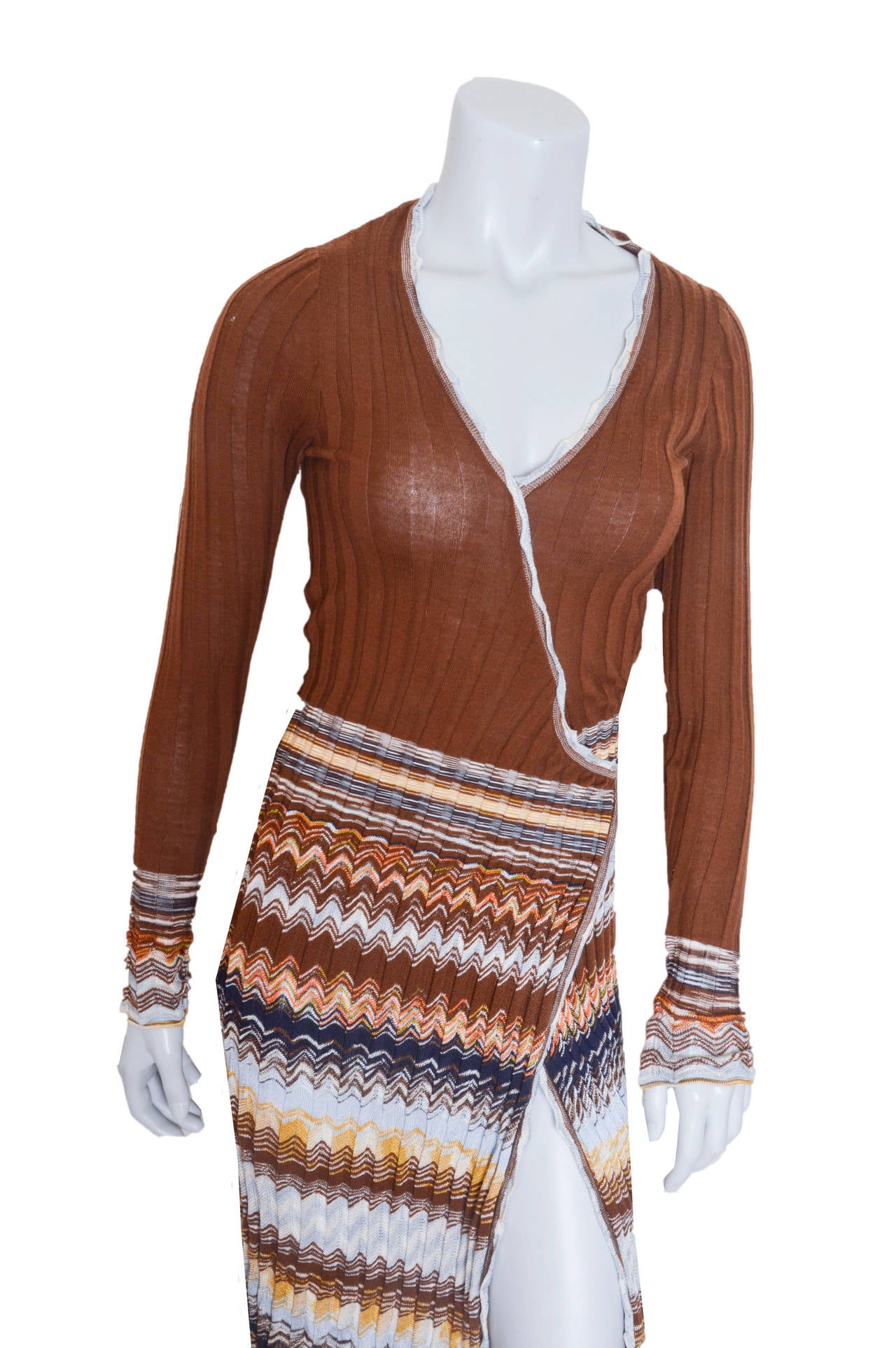 Body clinging faux wrap dress by M Missoni.
Ribbed knit wrap bodice is stitched down.
Skirt features actual wrap skirt with tie that secures in back.
Signature zig zag design on skirt and cuffs.
Very stretchy and body conscious.
Tagged a US 4.