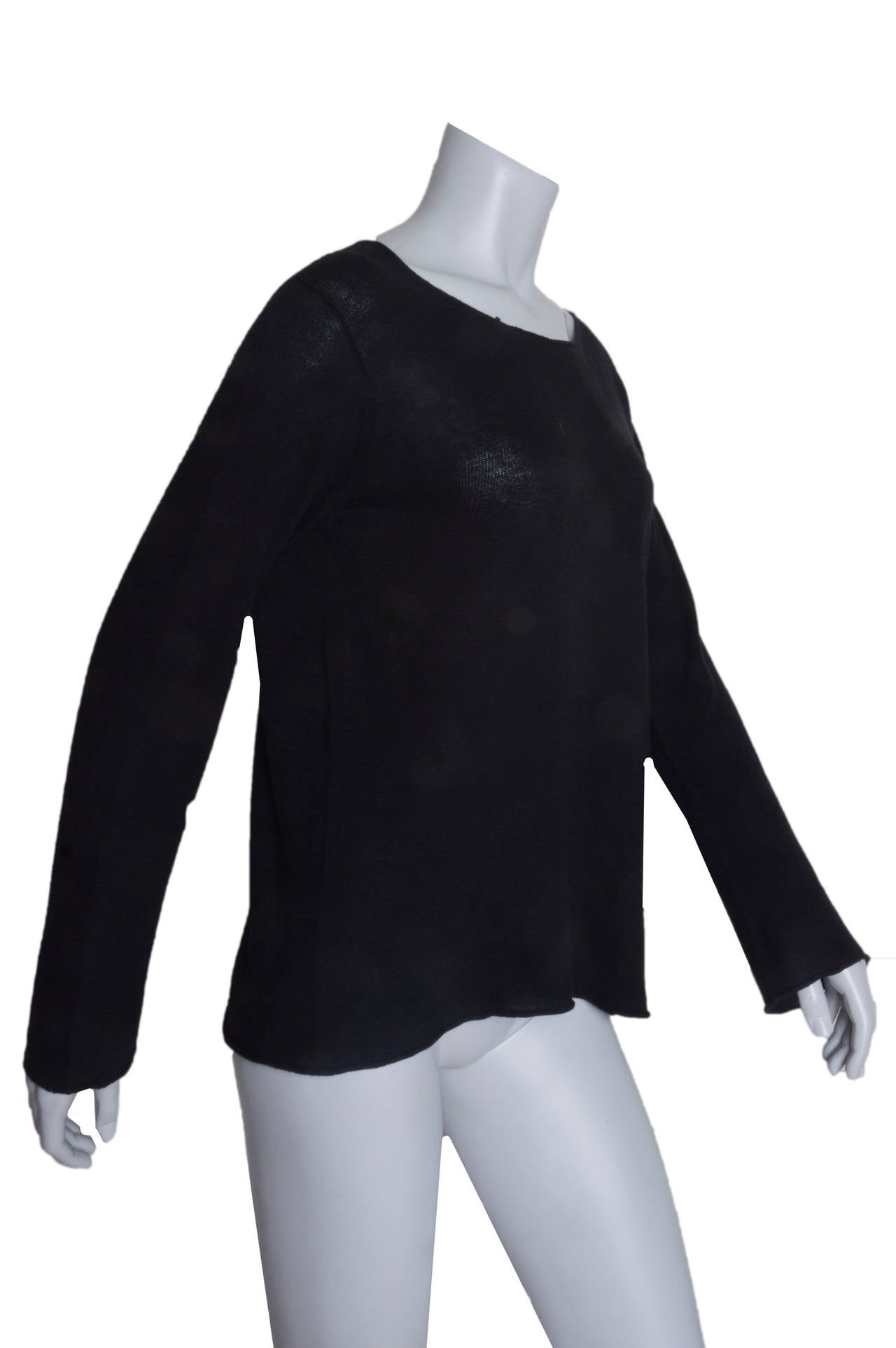 Comme Des Garcons black pull over sweater.
Longer, loose easy shape.
Scoop neck.
Slightly rolled hem.
Tagged a size Small.